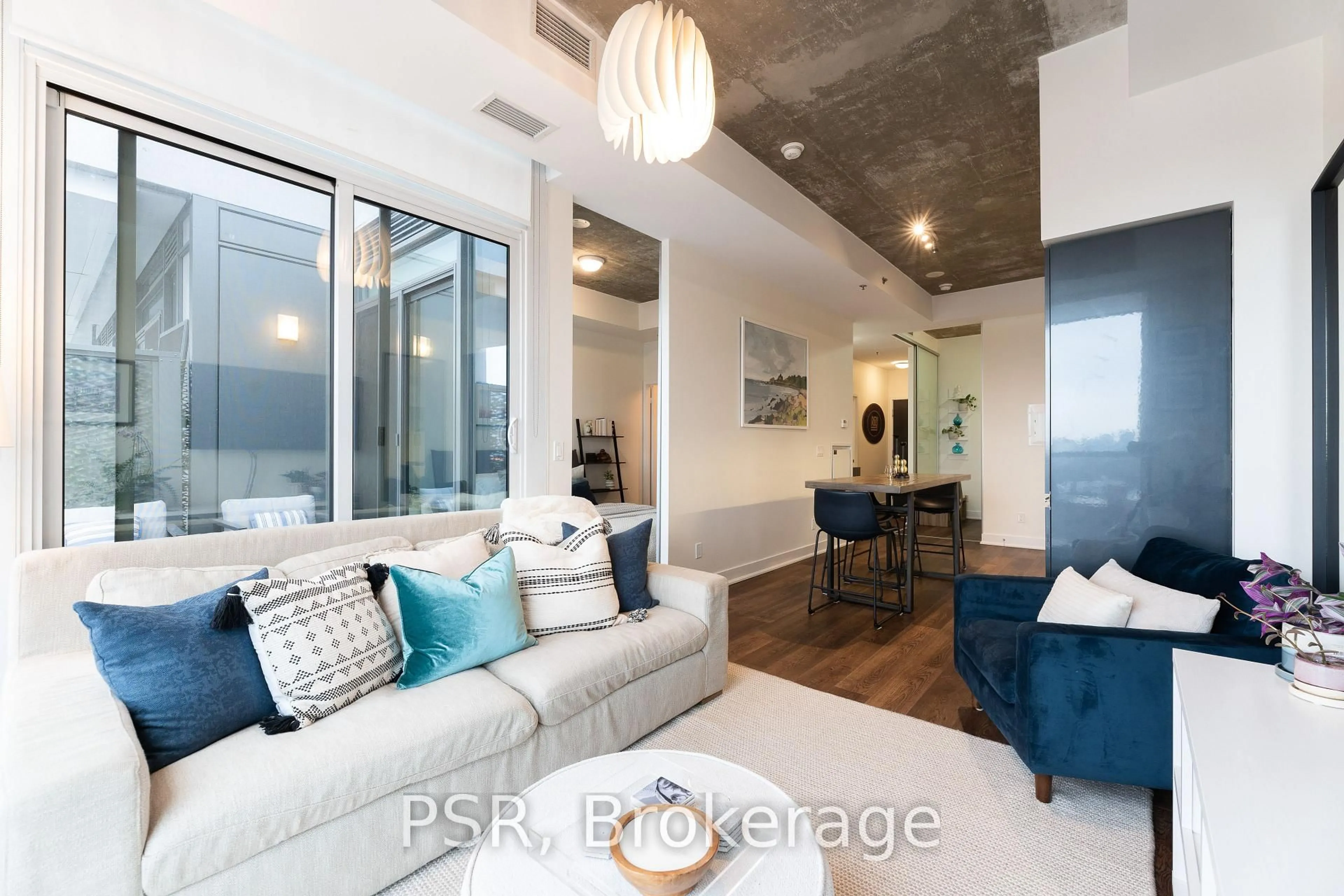 Living room with furniture, cement floor for 20 Minowan Miikan Lane #1118, Toronto Ontario M6J 0E5