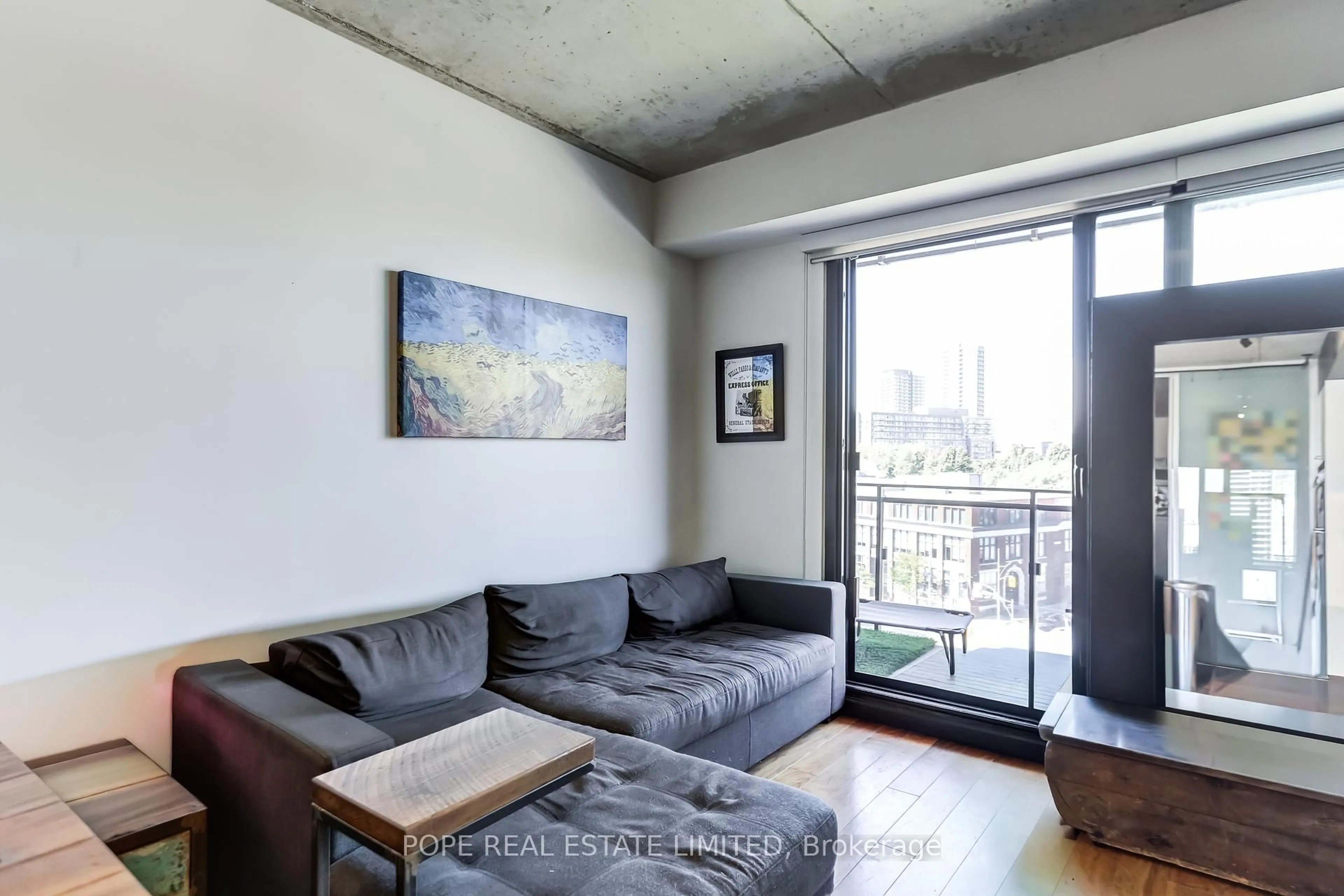 Living room with furniture, cement floor for 51 Trolley Cres #719, Toronto Ontario M5A 0E9