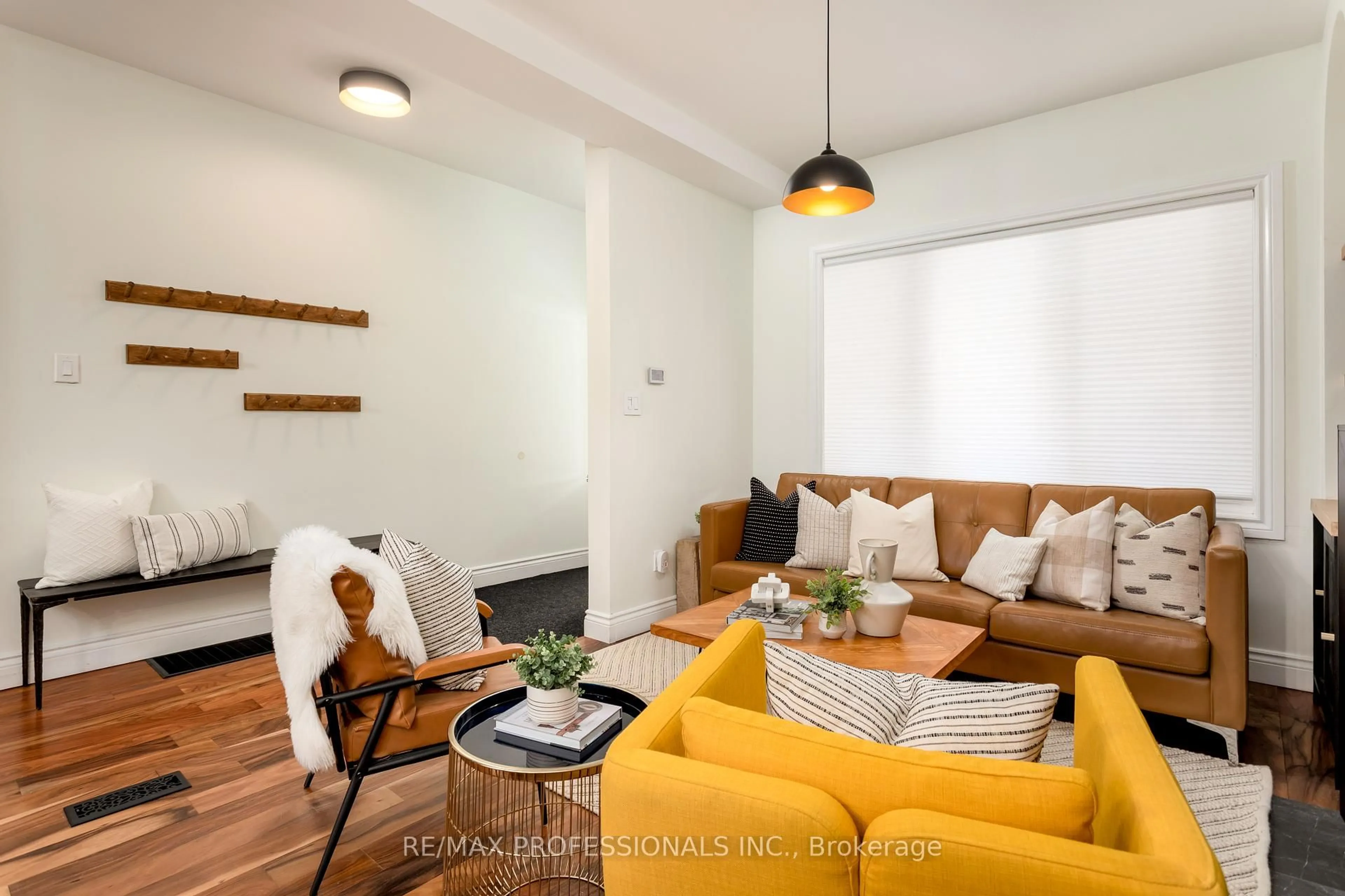 Living room with furniture, wood/laminate floor for 211 Markham St, Toronto Ontario M6J 2G7