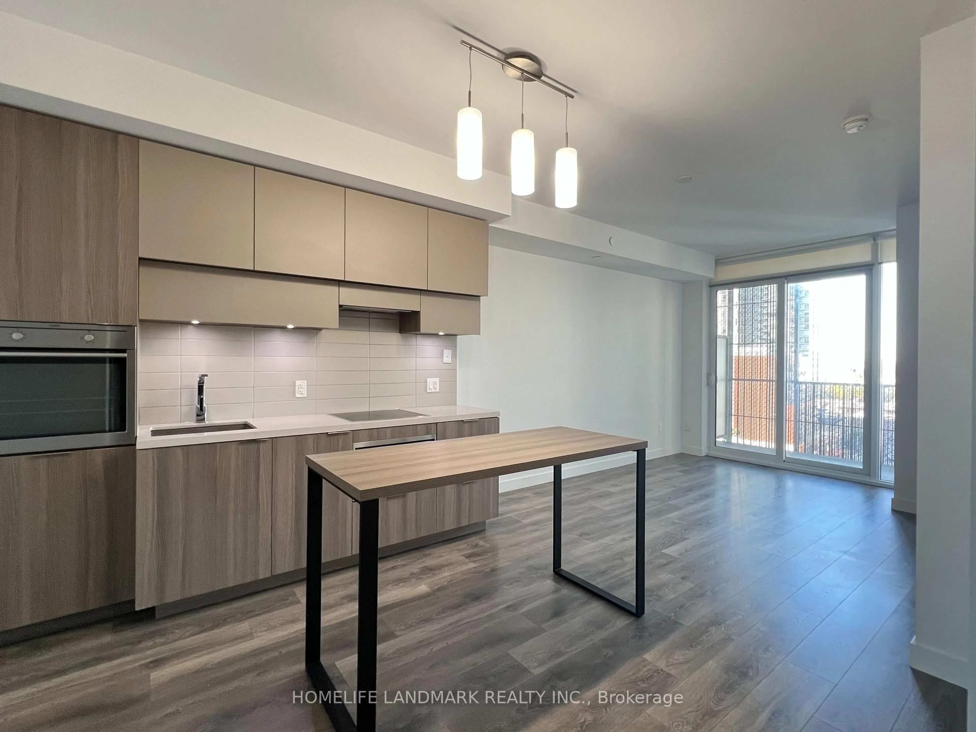 Open concept kitchen, wood/laminate floor for 8 Eglinton Ave #1007, Toronto Ontario M4P 1A6