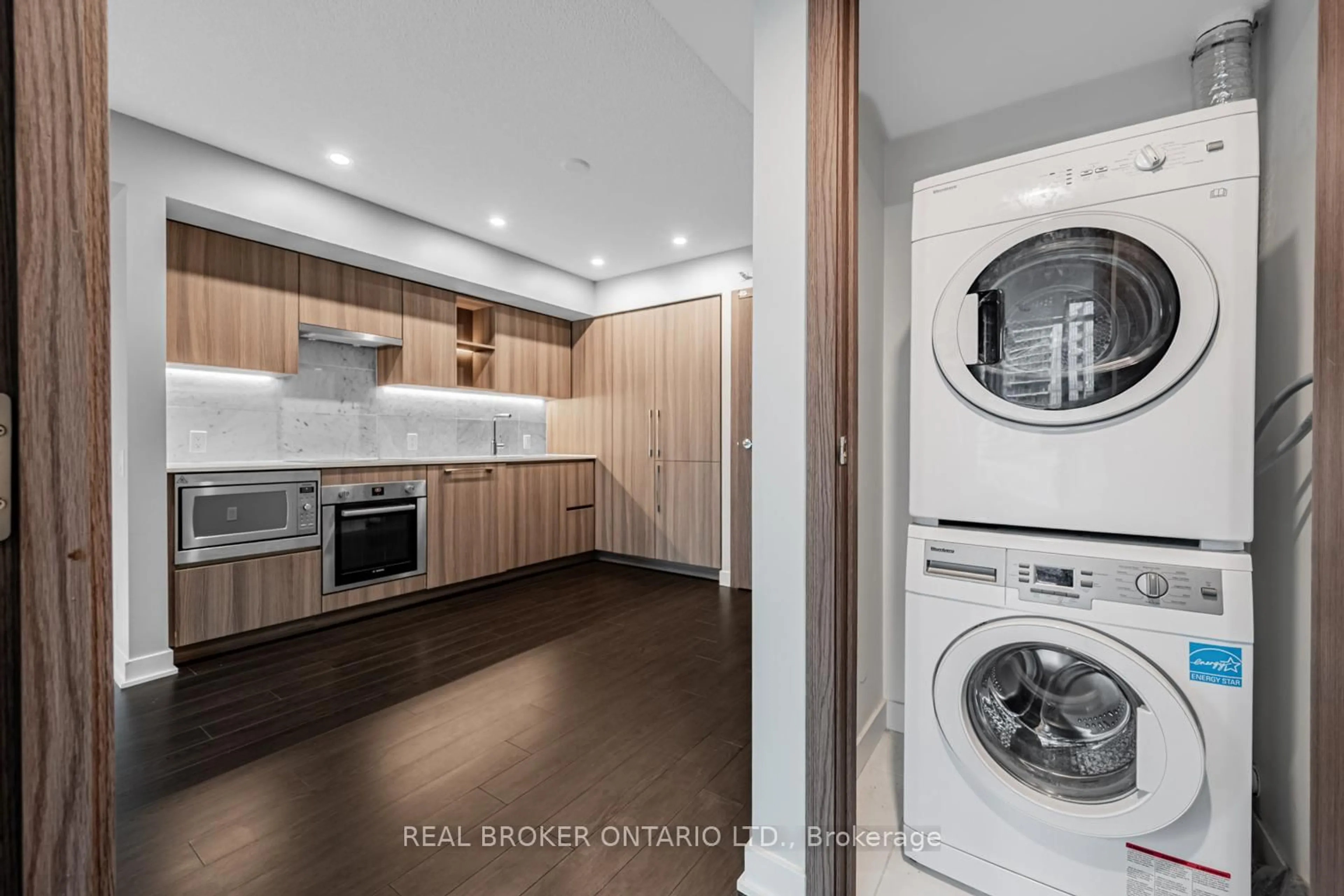 Kitchen with laundary machines, wood/laminate floor for 19 Bathurst St #816, Toronto Ontario M5V 0P8