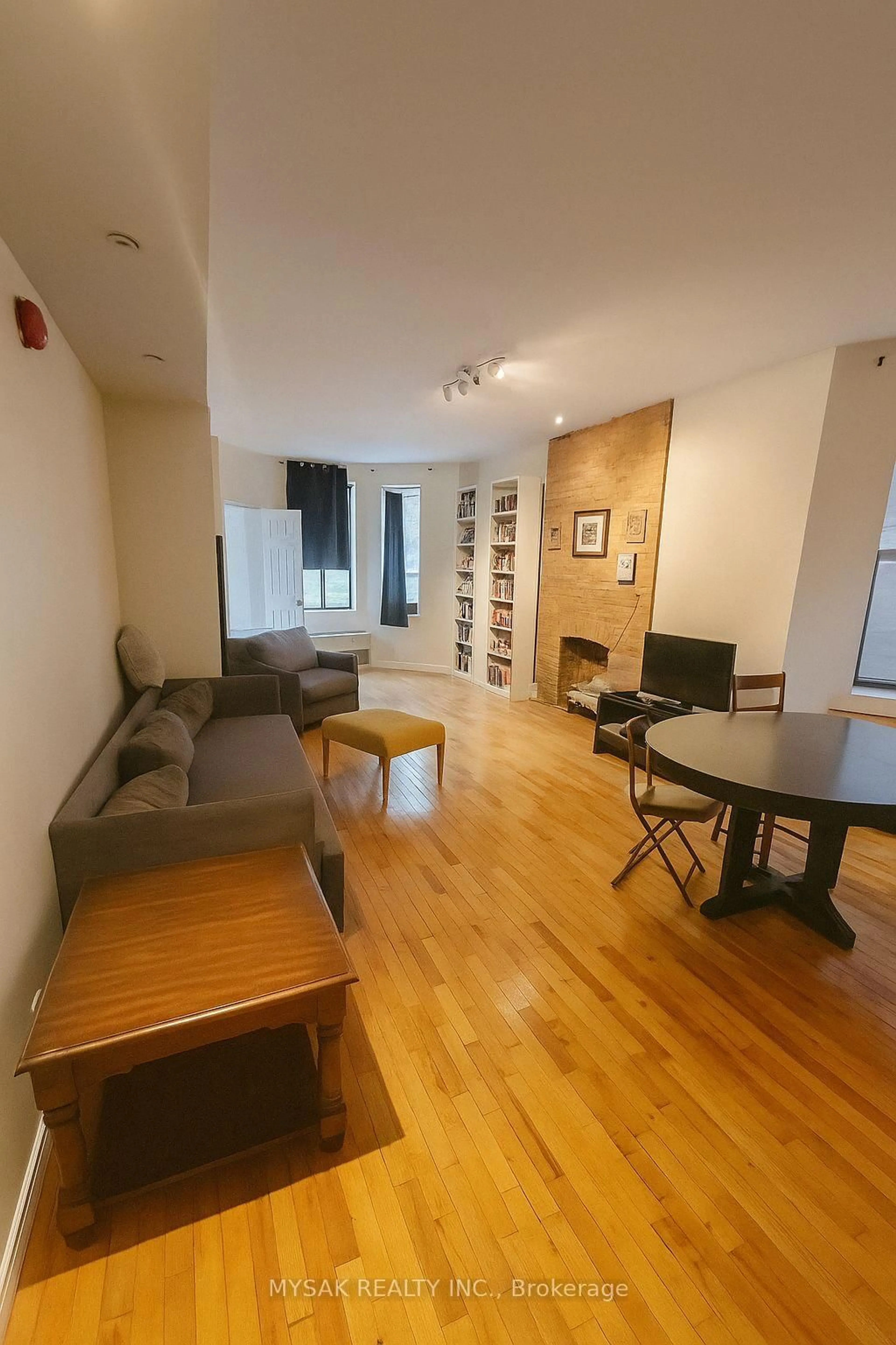 Living room with furniture, wood/laminate floor for 50-52 Dundonald St, Toronto Ontario M4Y 1K2