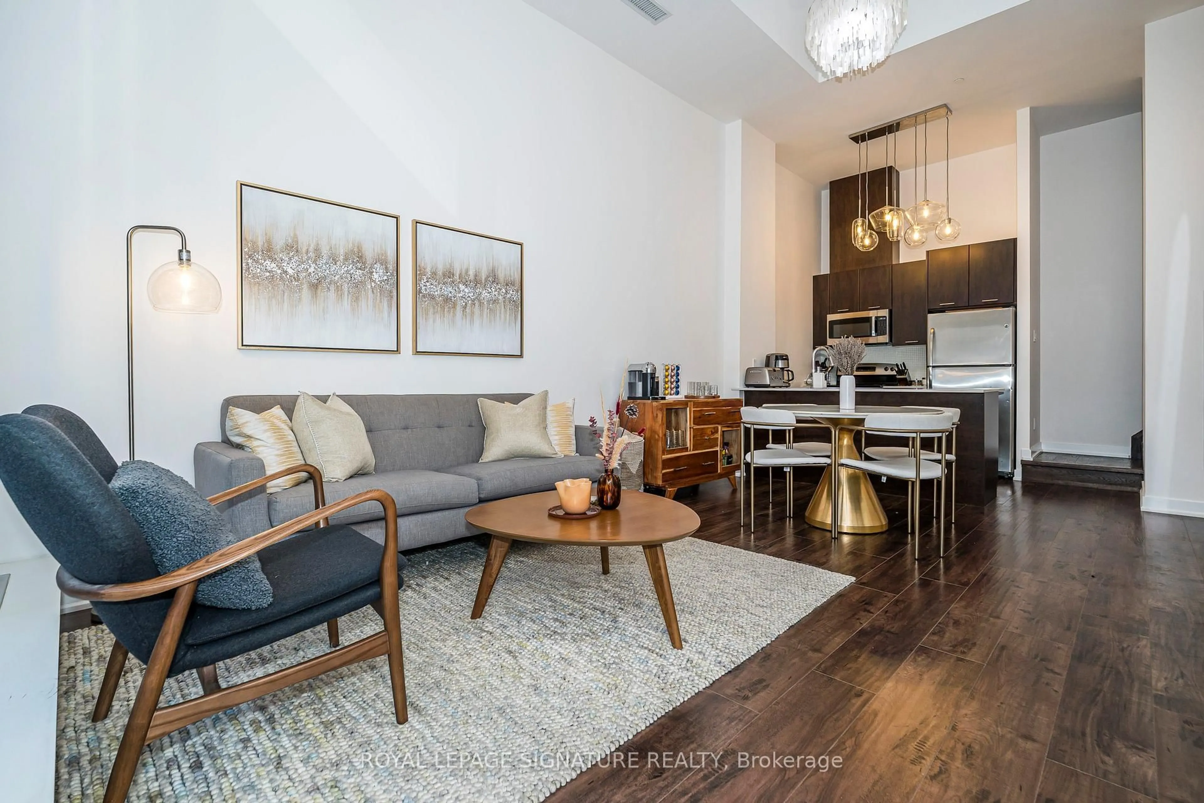 Living room with furniture, wood/laminate floor for 20 Bruyeres Mews #TH05, Toronto Ontario M5V 0G8