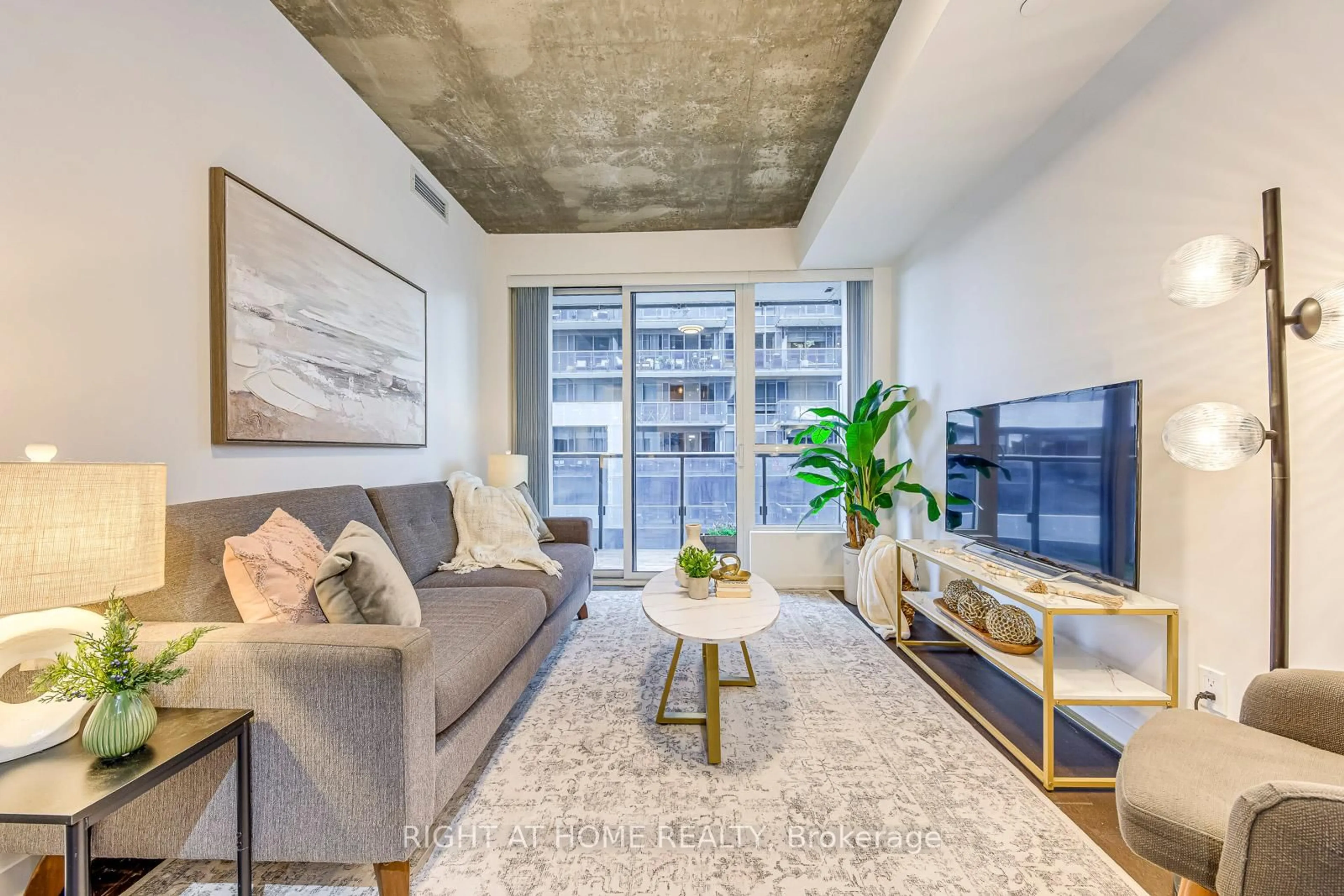 Living room with furniture, cement floor for 1030 King St #748, Toronto Ontario M6K 0B4