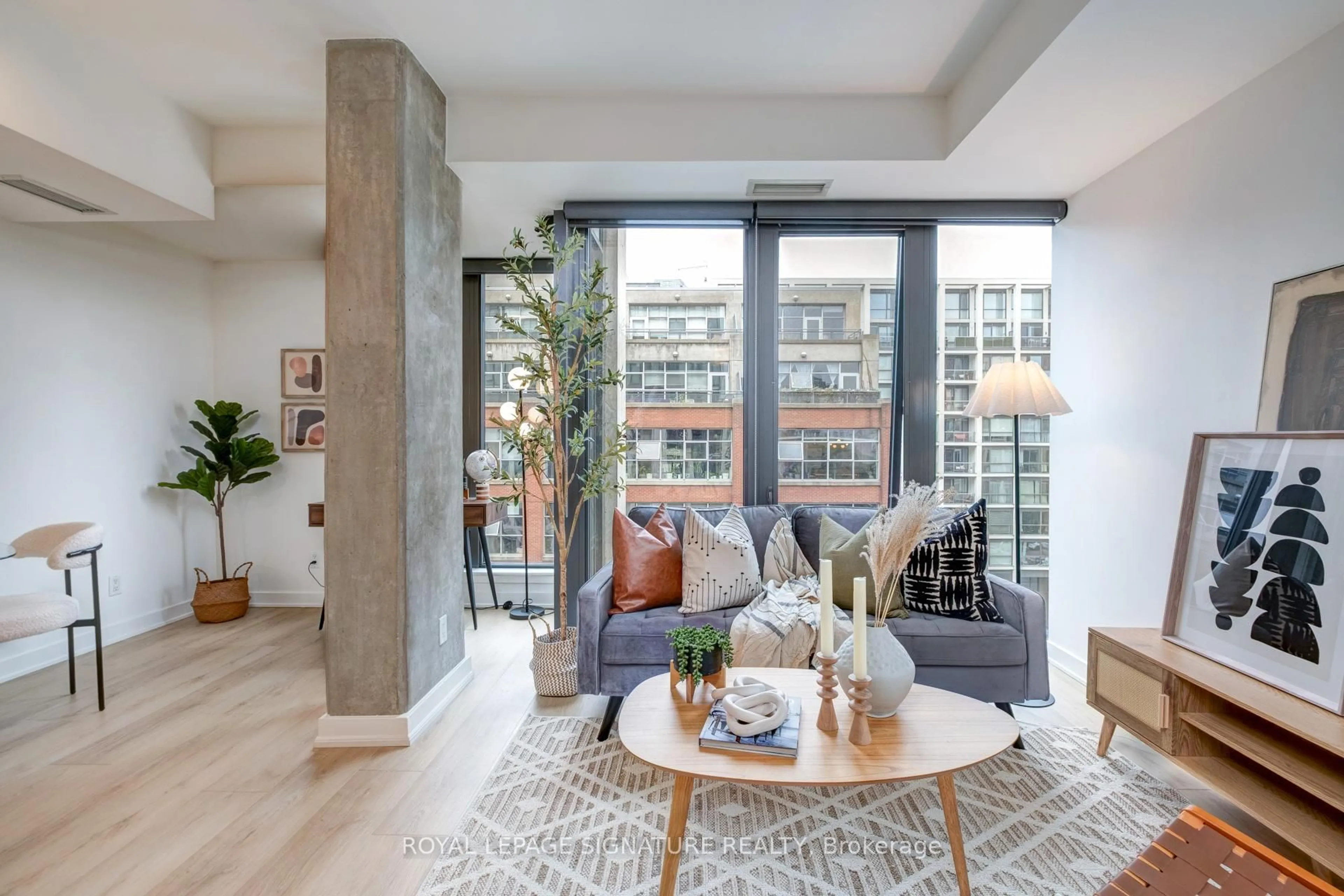 Living room with furniture, cement floor for 32 Camden St #704, Toronto Ontario M5V 0G4