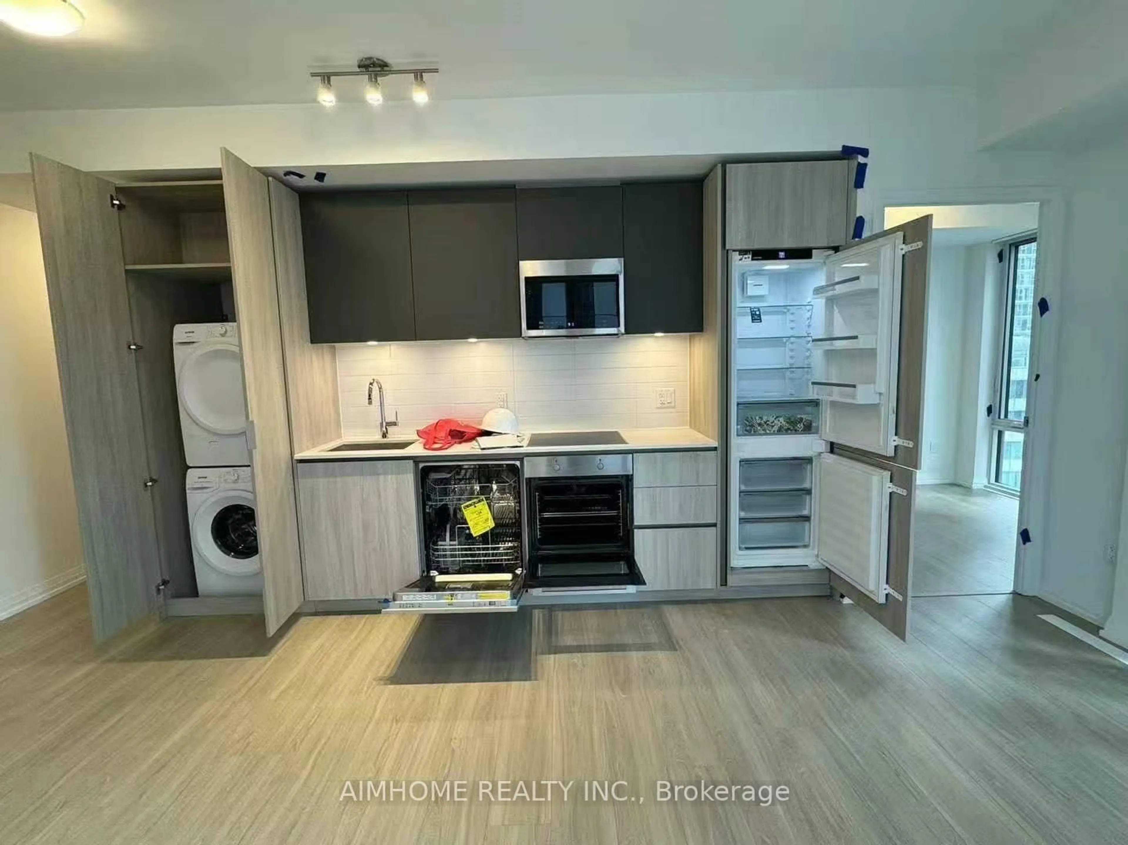 Kitchen with laundary machines, wood/laminate floor for 8 Widmer St #2903, Toronto Ontario M5V 2E7