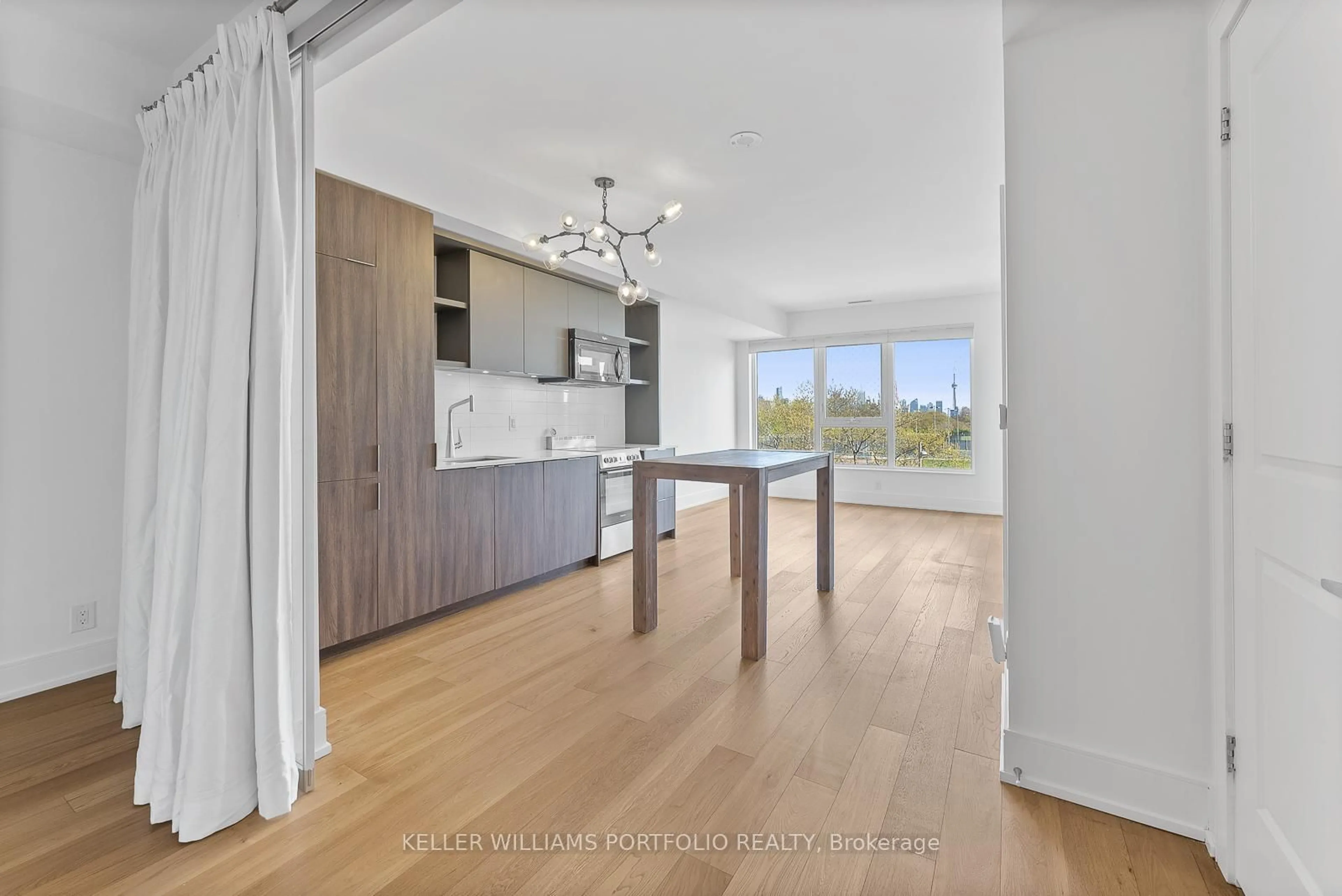 Open concept kitchen, wood/laminate floor for 6 Parkwood Ave #310, Toronto Ontario M4V 2W8