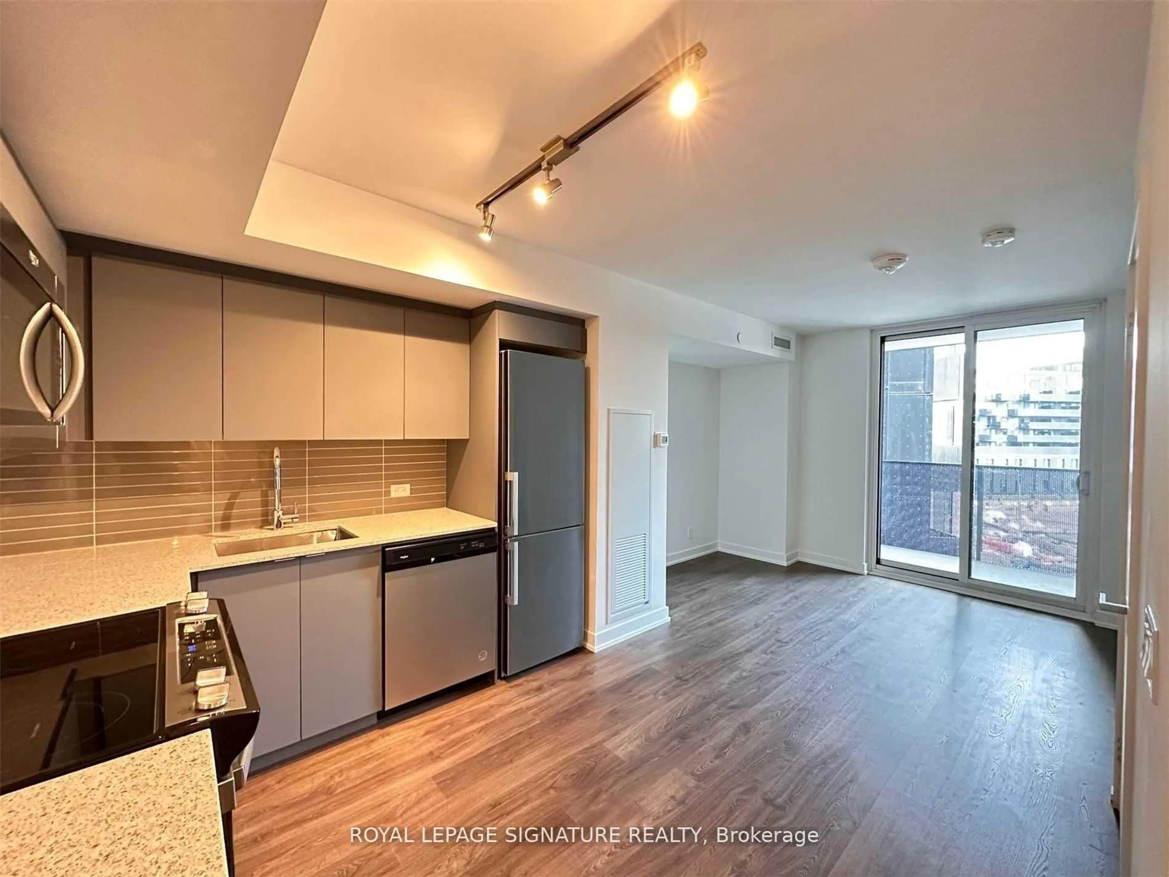 Open concept kitchen, wood/laminate floor for 30 Tretti Way #406, Toronto Ontario M3H 0E3