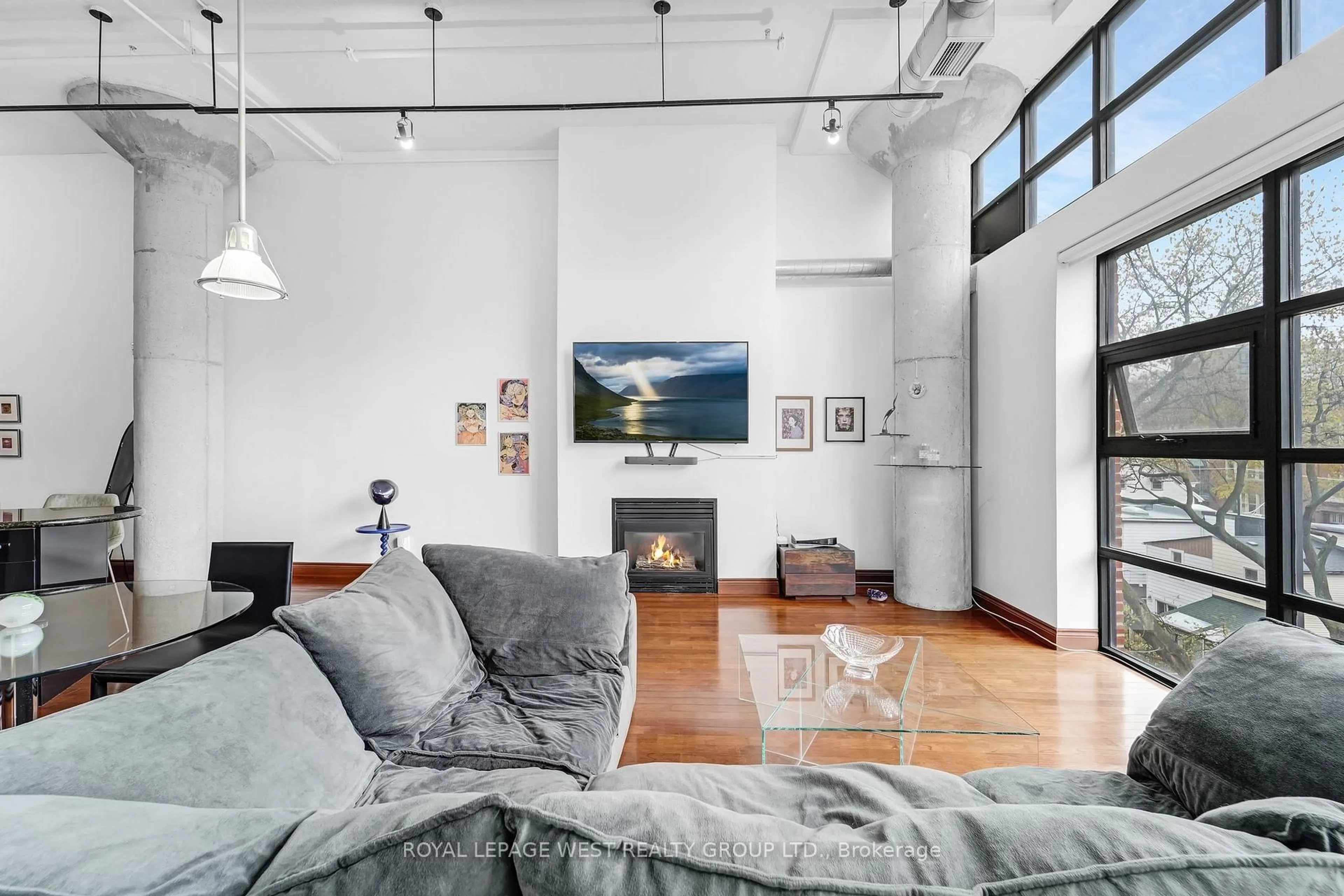 Living room with furniture, cement floor for 90 Sumach St #416, Toronto Ontario M5A 4R4