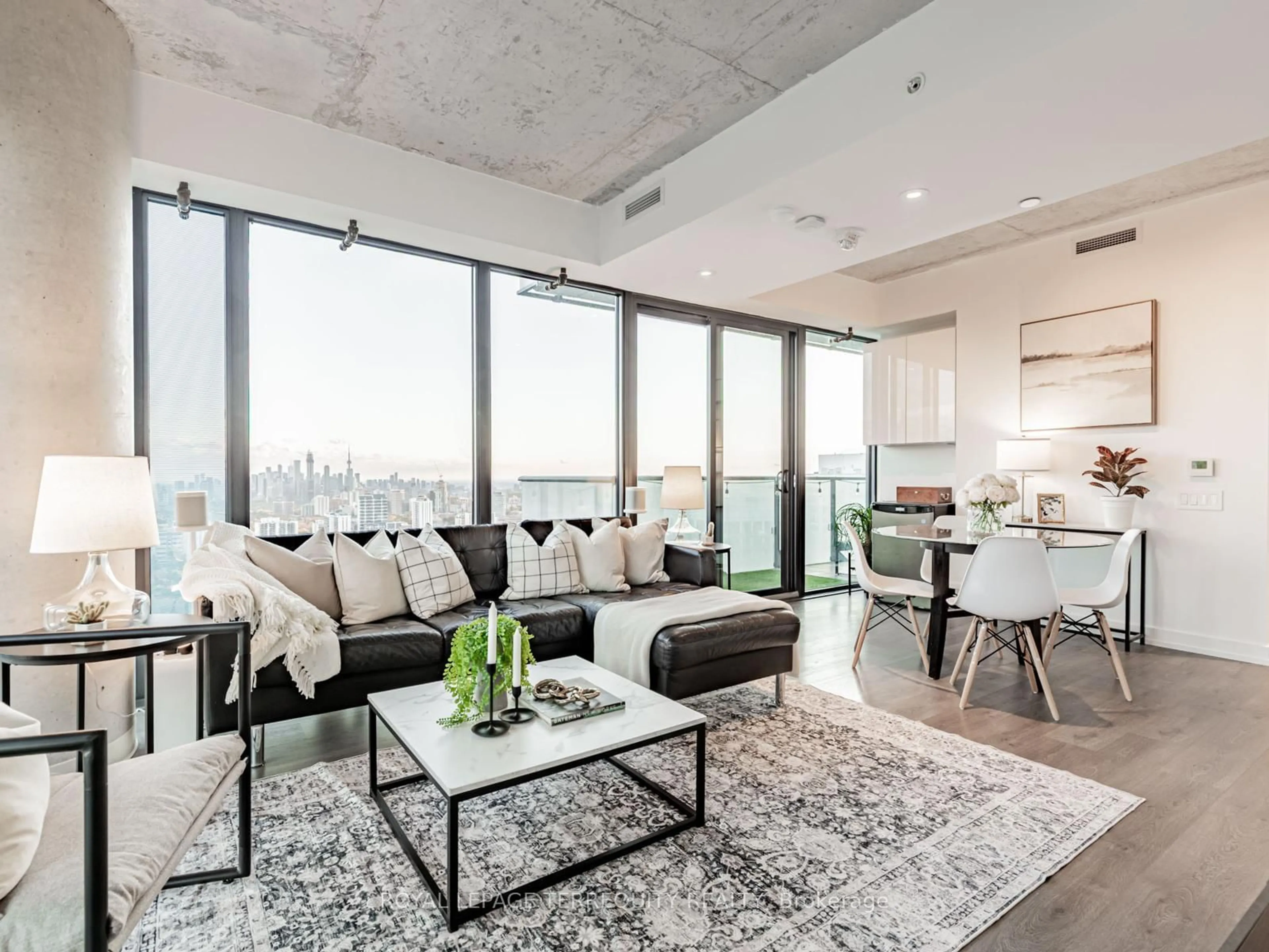 Living room with furniture, cement floor for 161 Roehampton Ave #4209, Toronto Ontario M4P 0C8