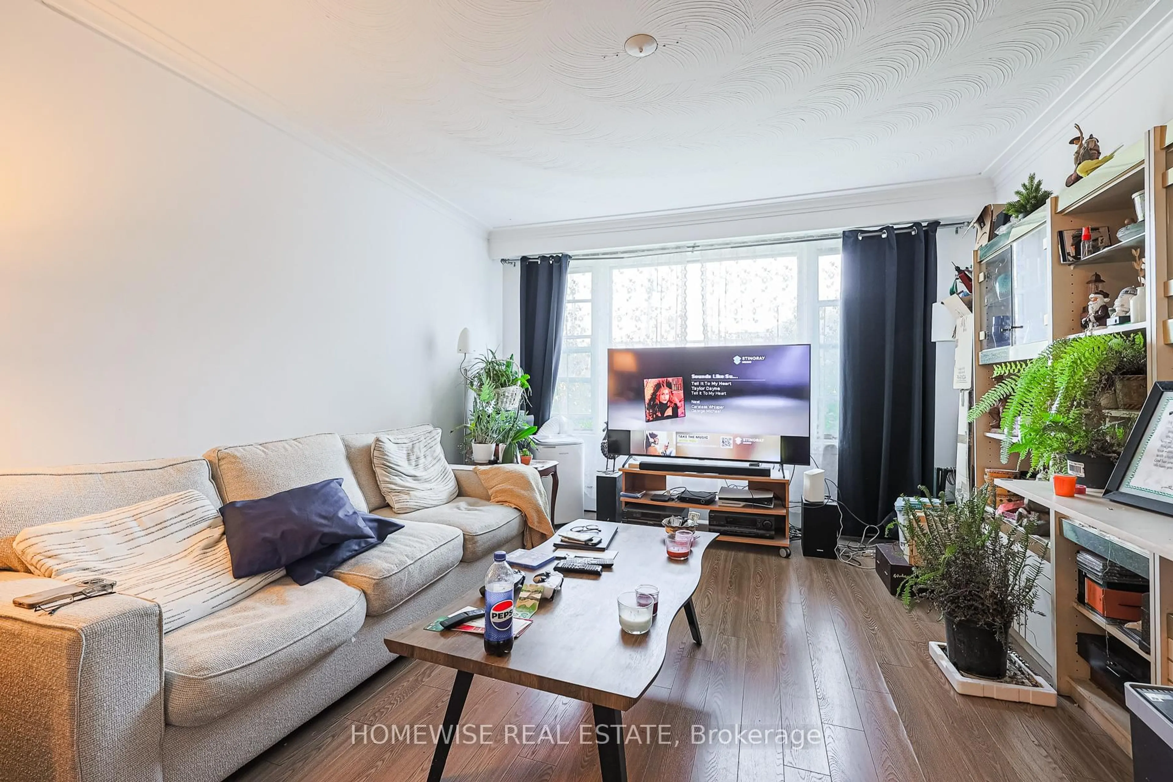 Living room with furniture, wood/laminate floor for 4 Lanark Ave, Toronto Ontario M6C 2B3