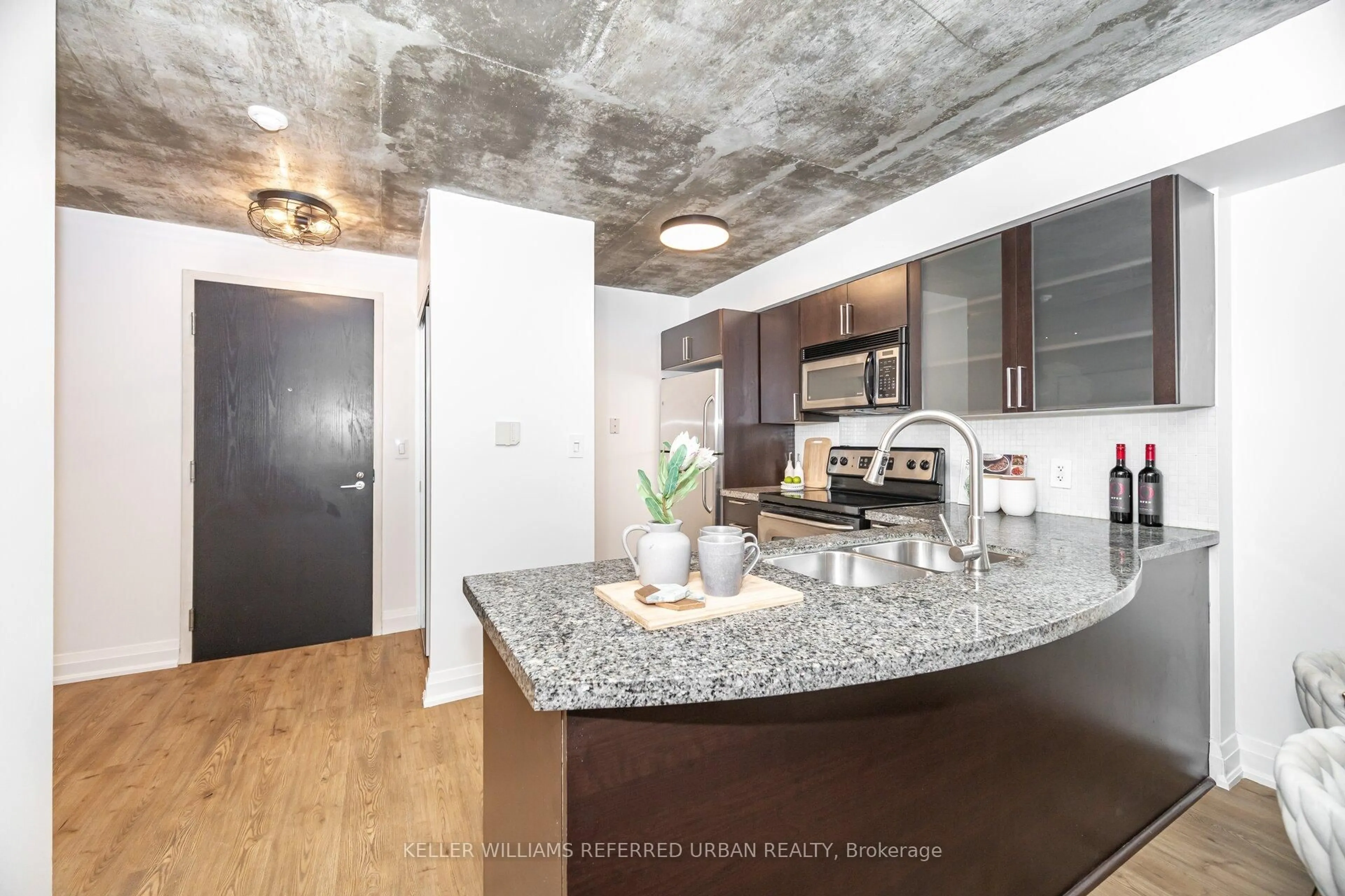 Open concept kitchen, cement floor for 1005 King St #414, Toronto Ontario M6K 3M8