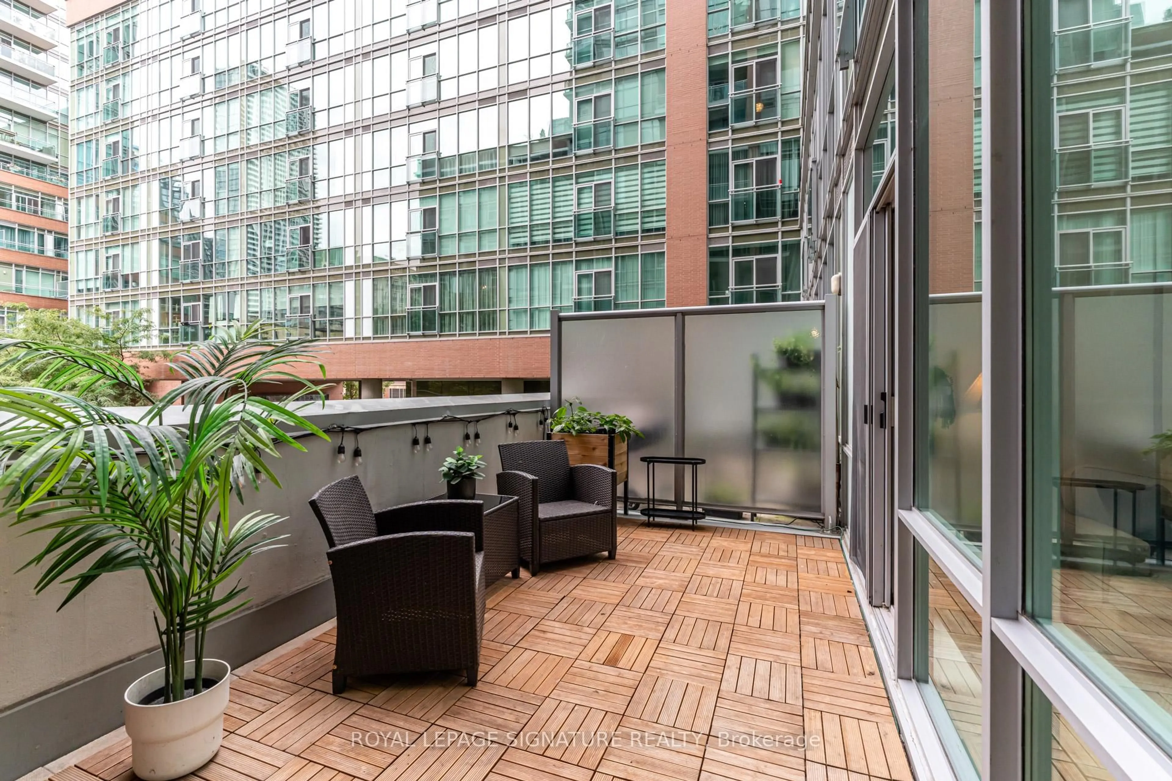 Patio, city buildings view from balcony for 112 George St #S203, Toronto Ontario M5A 2M5