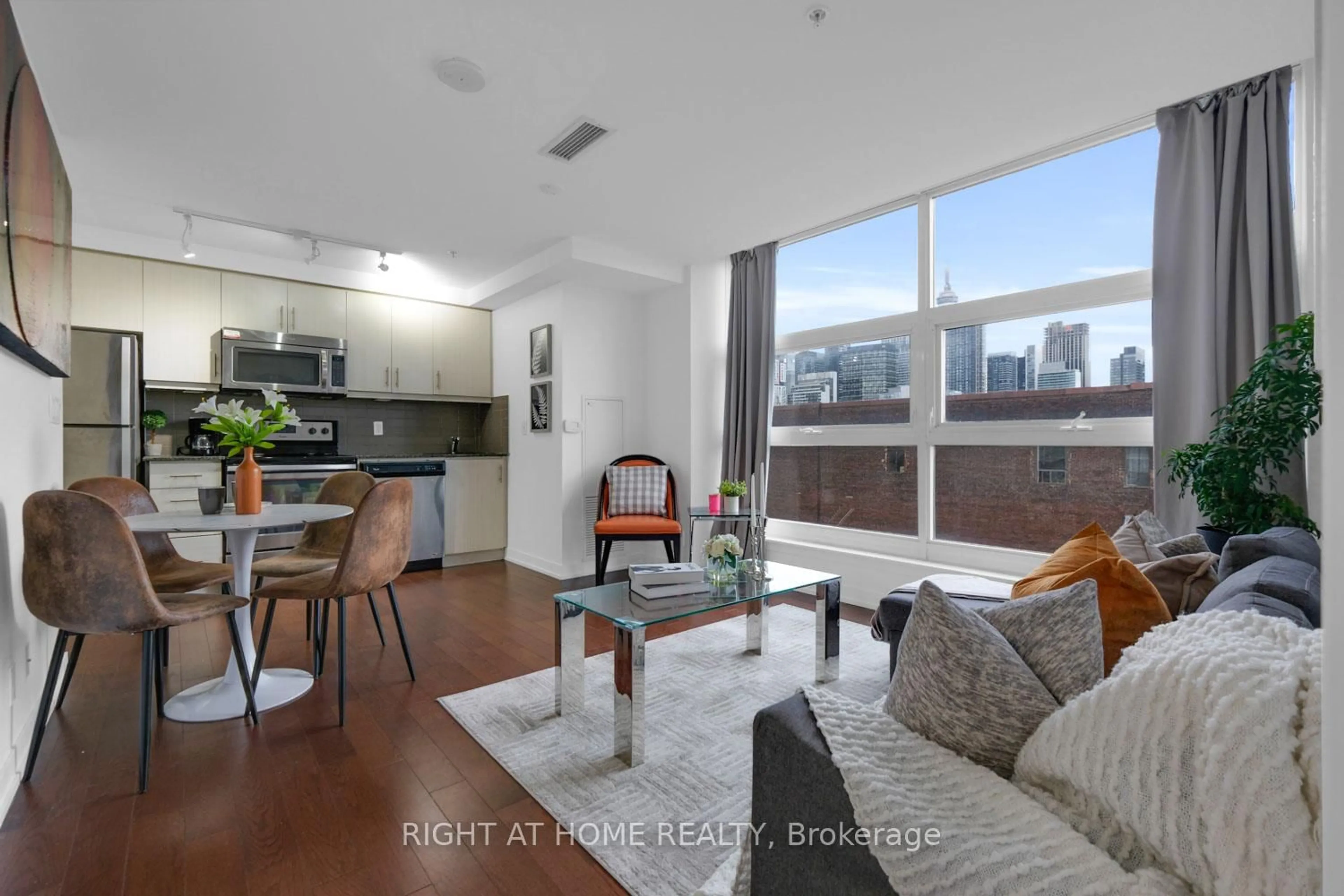 Living room with furniture, wood/laminate floor for 10 Willison Sq #701, Toronto Ontario M5T 0A8