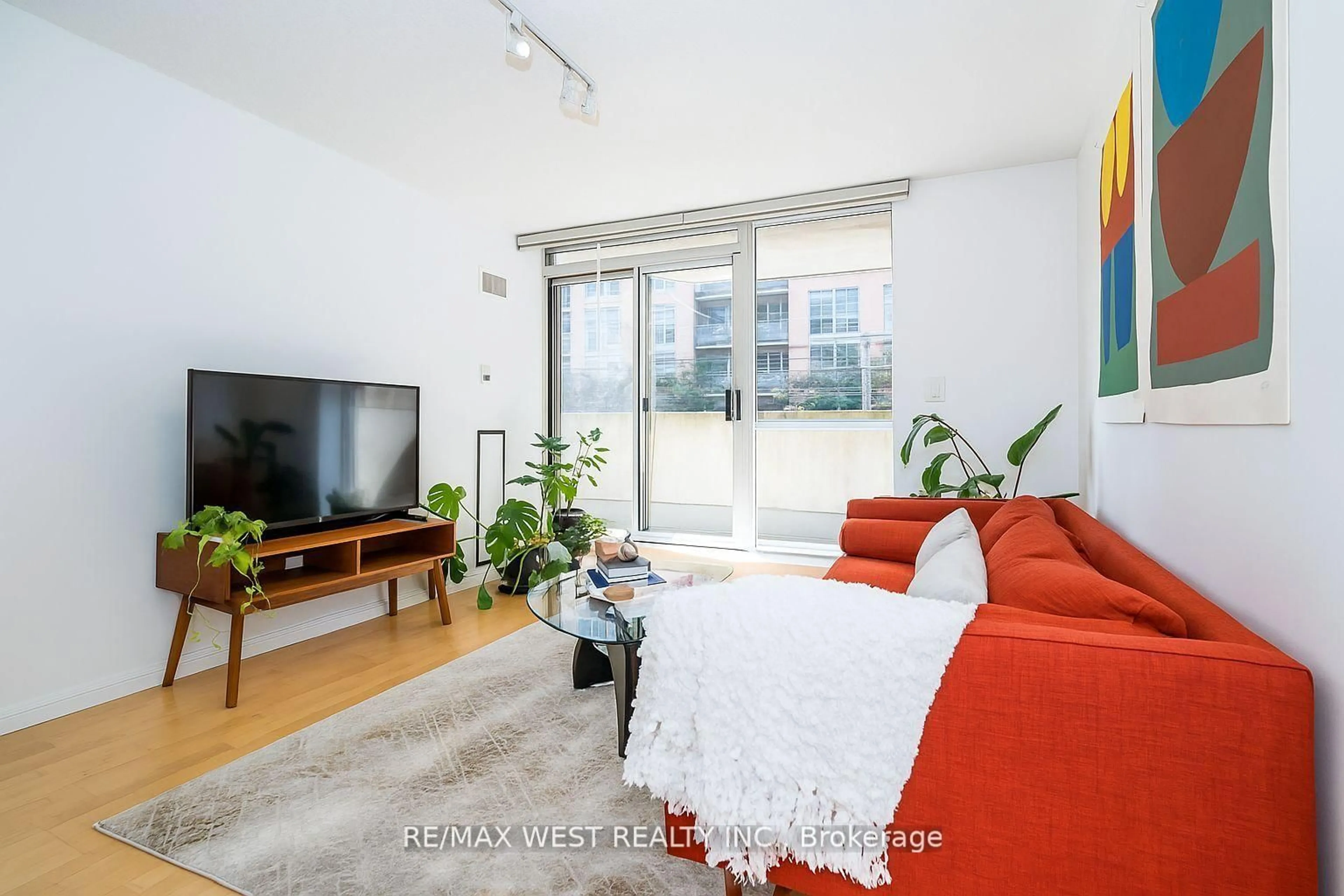 Living room with furniture, wood/laminate floor for 1000 King St #209, Toronto Ontario M6K 3N1