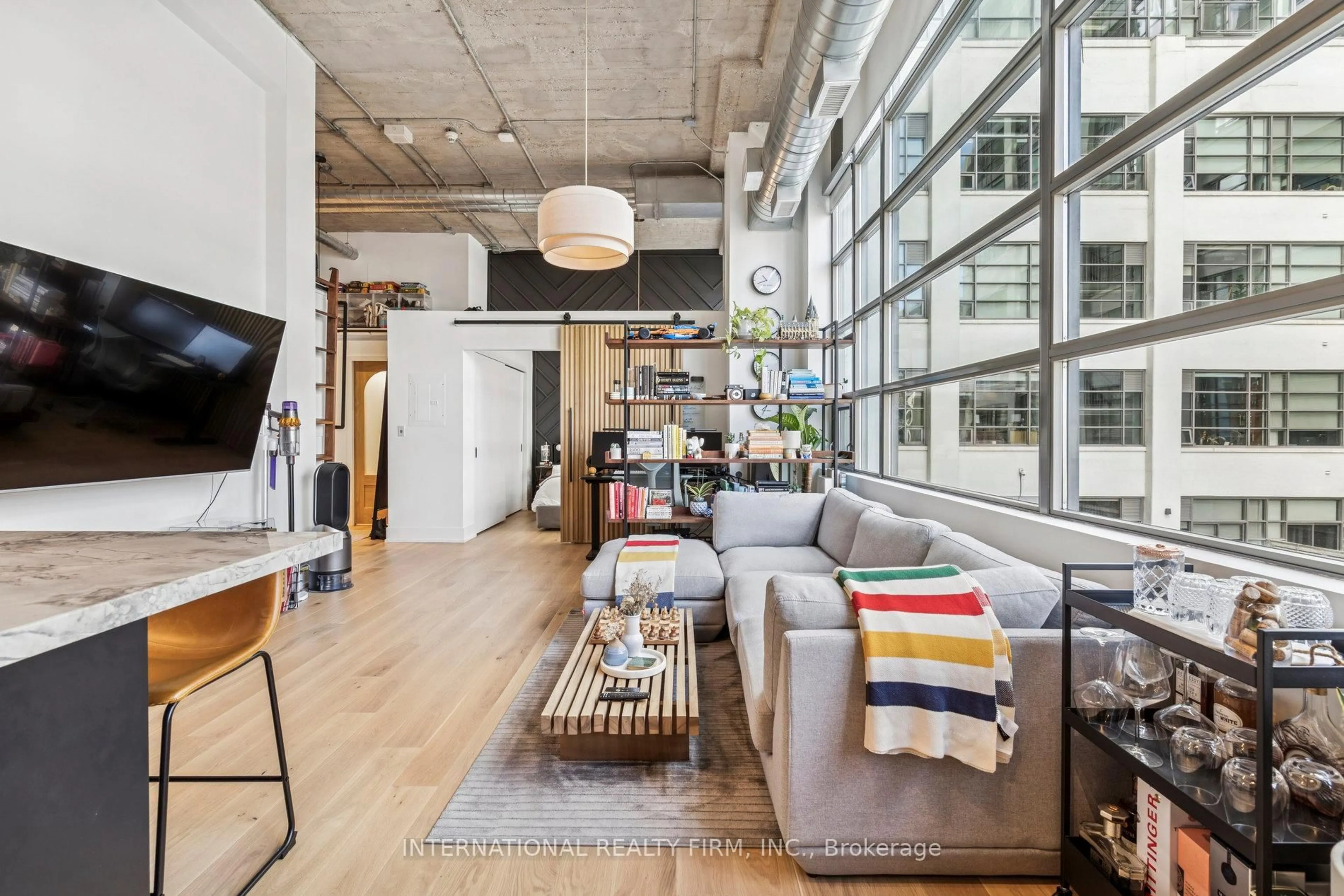 Living room with furniture, cement floor for 637 Lake Shore Blvd #303, Toronto Ontario M5V 3J6