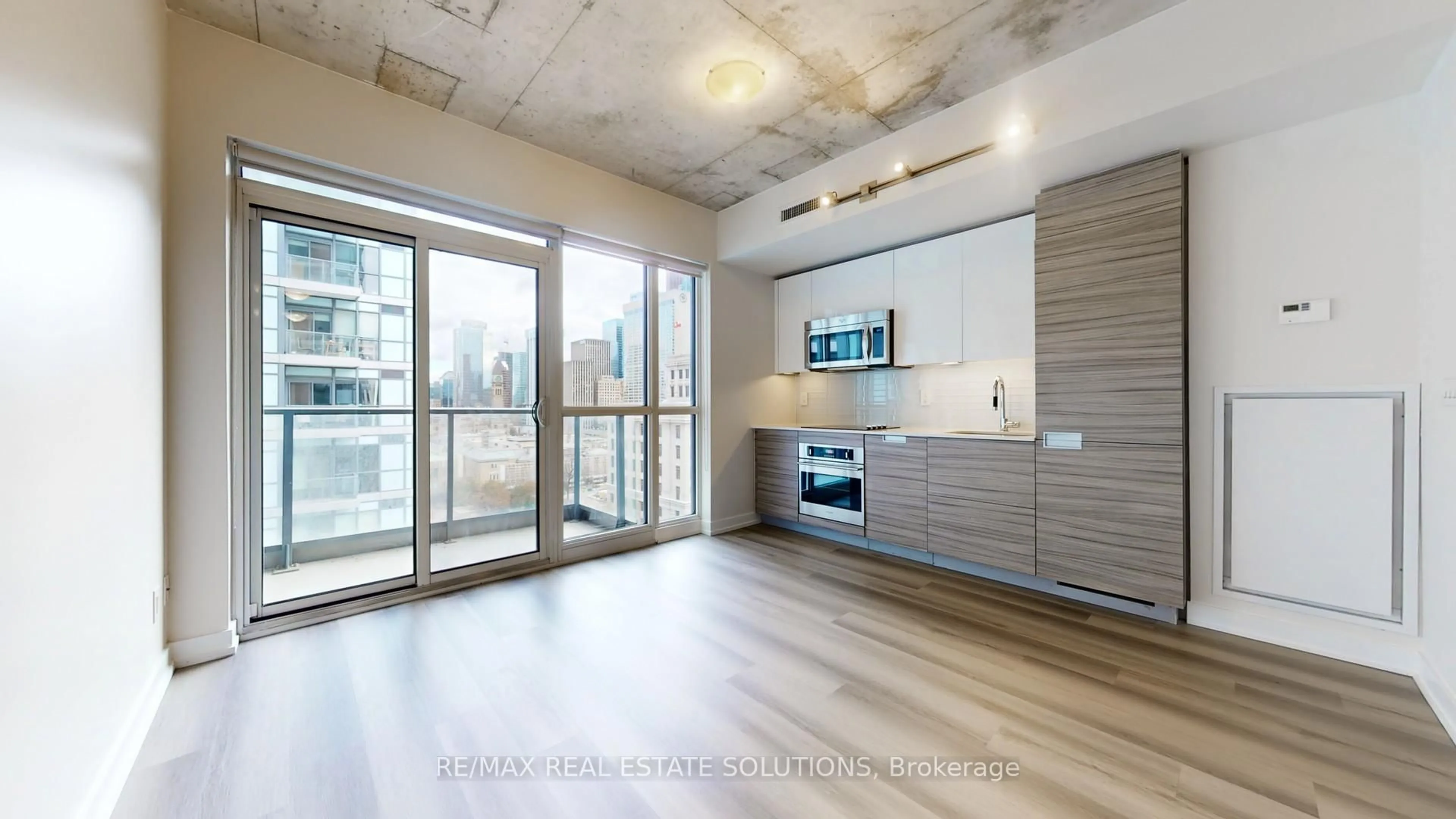 Open concept kitchen, wood/laminate floor for 210 Simcoe St #1303, Toronto Ontario M5T 0A9