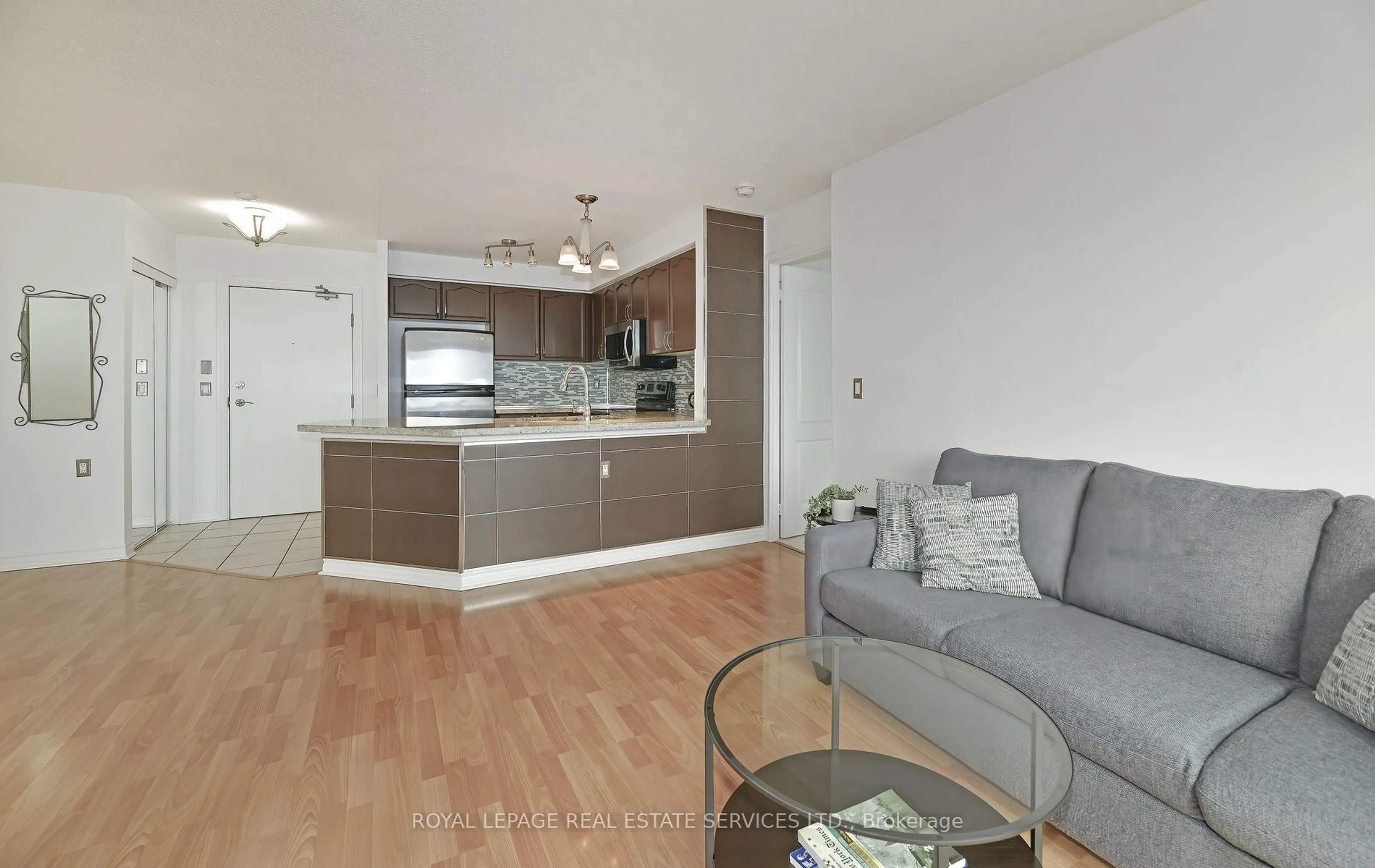 Living room with furniture, wood/laminate floor for 1030 Sheppard Ave #906, Toronto Ontario M3H 6C1