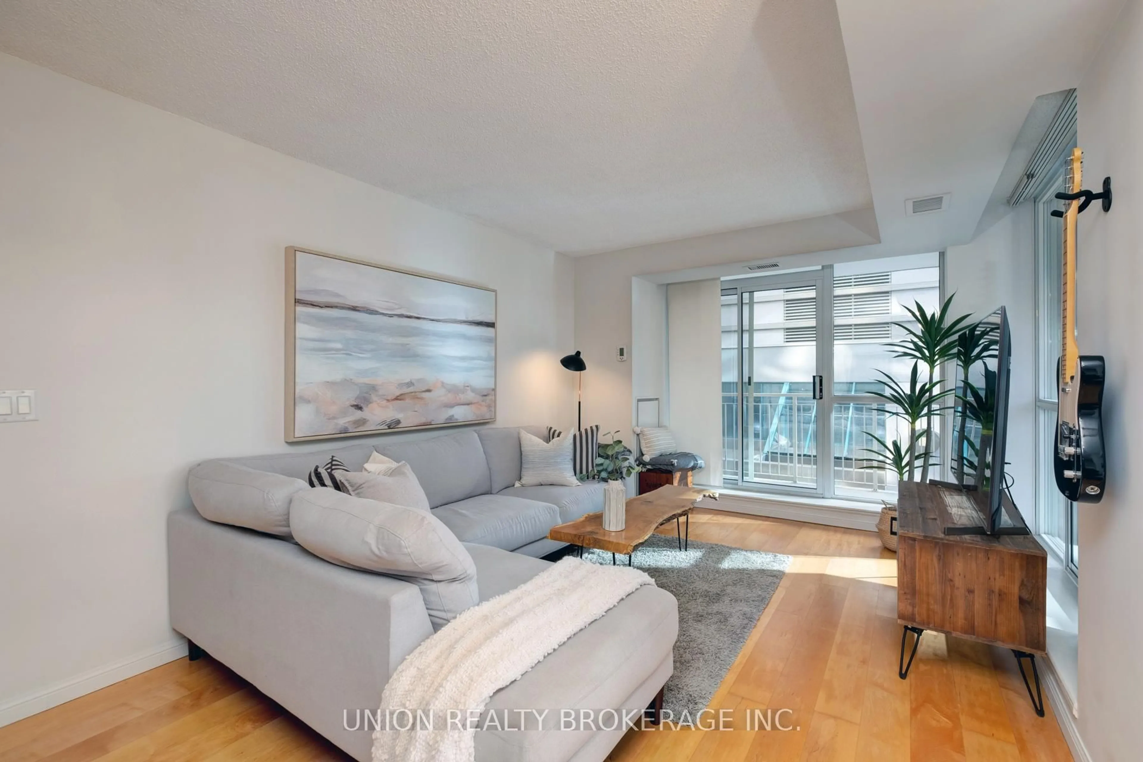 Living room with furniture, wood/laminate floor for 18 Stafford St #313, Toronto Ontario M5V 3W4