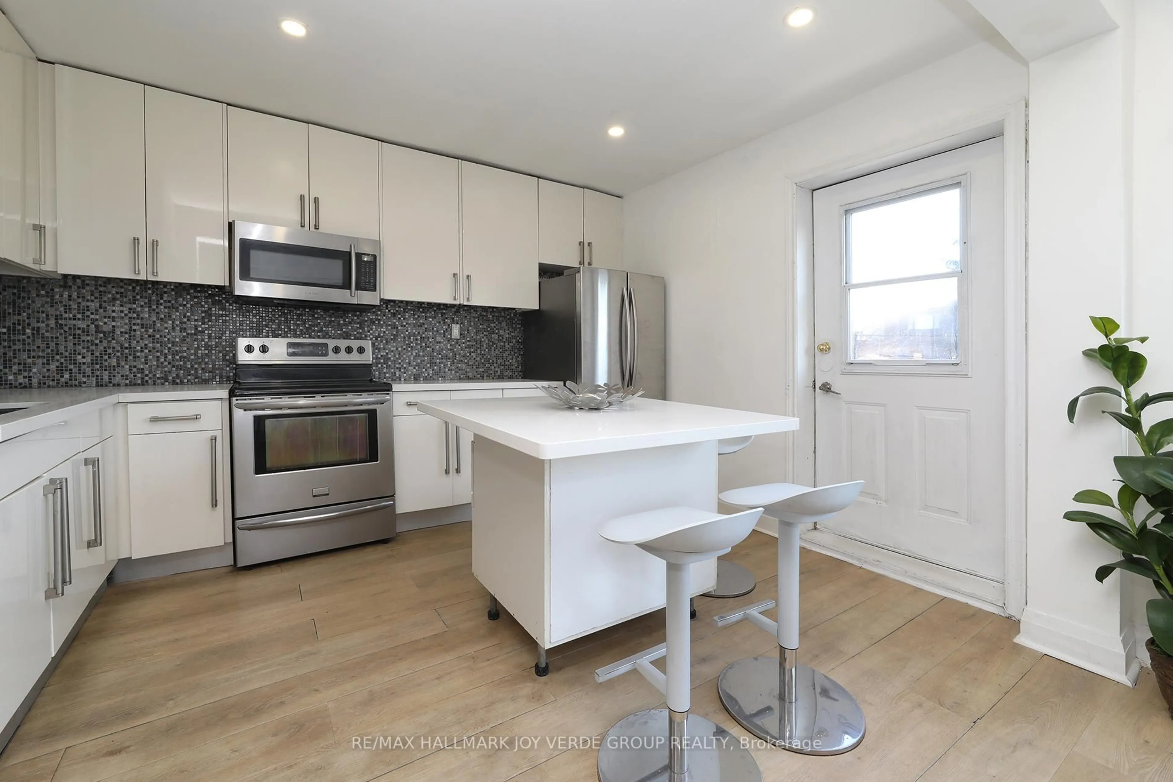 Open concept kitchen, wood/laminate floor for 275 Lauder Ave, Toronto Ontario M6E 3H5
