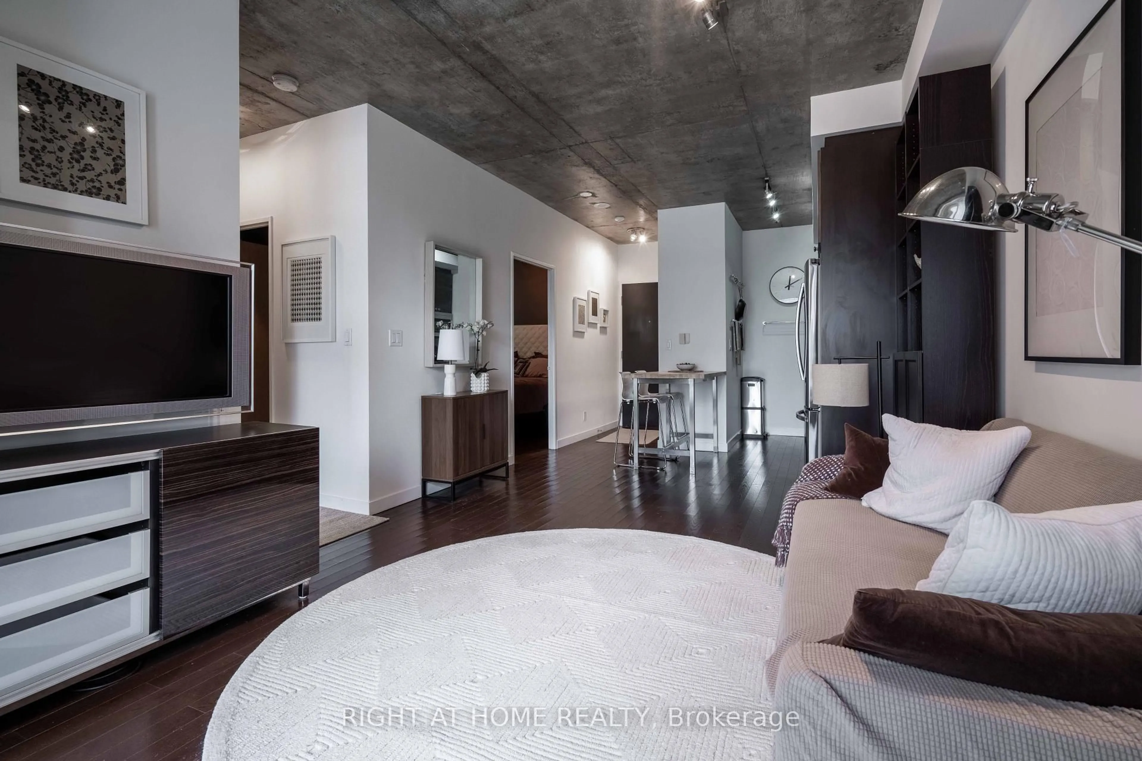 Living room with furniture, cement floor for 1 Shaw St #413, Toronto Ontario M6K 0A1