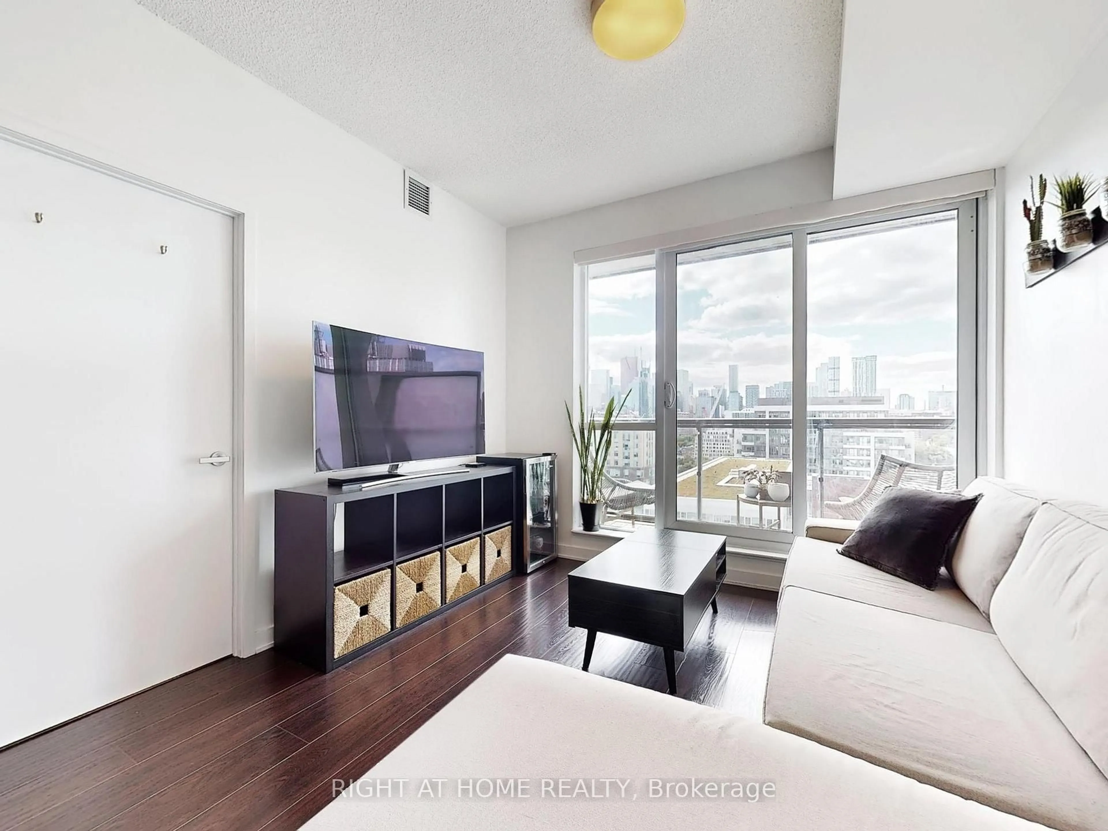 Living room with furniture, wood/laminate floor for 55 Regent Park Blvd #1407, Toronto Ontario M5A 0C2