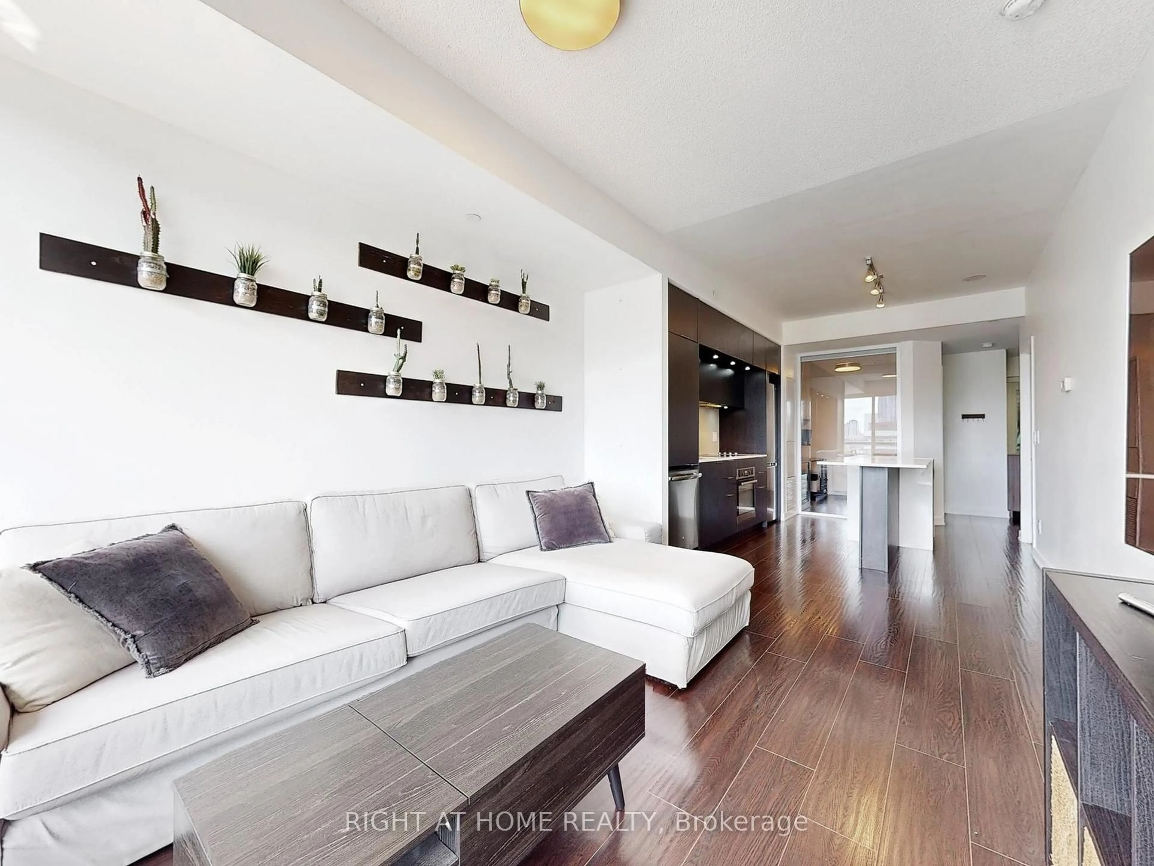 Living room with furniture, wood/laminate floor for 55 Regent Park Blvd #1407, Toronto Ontario M5A 0C2