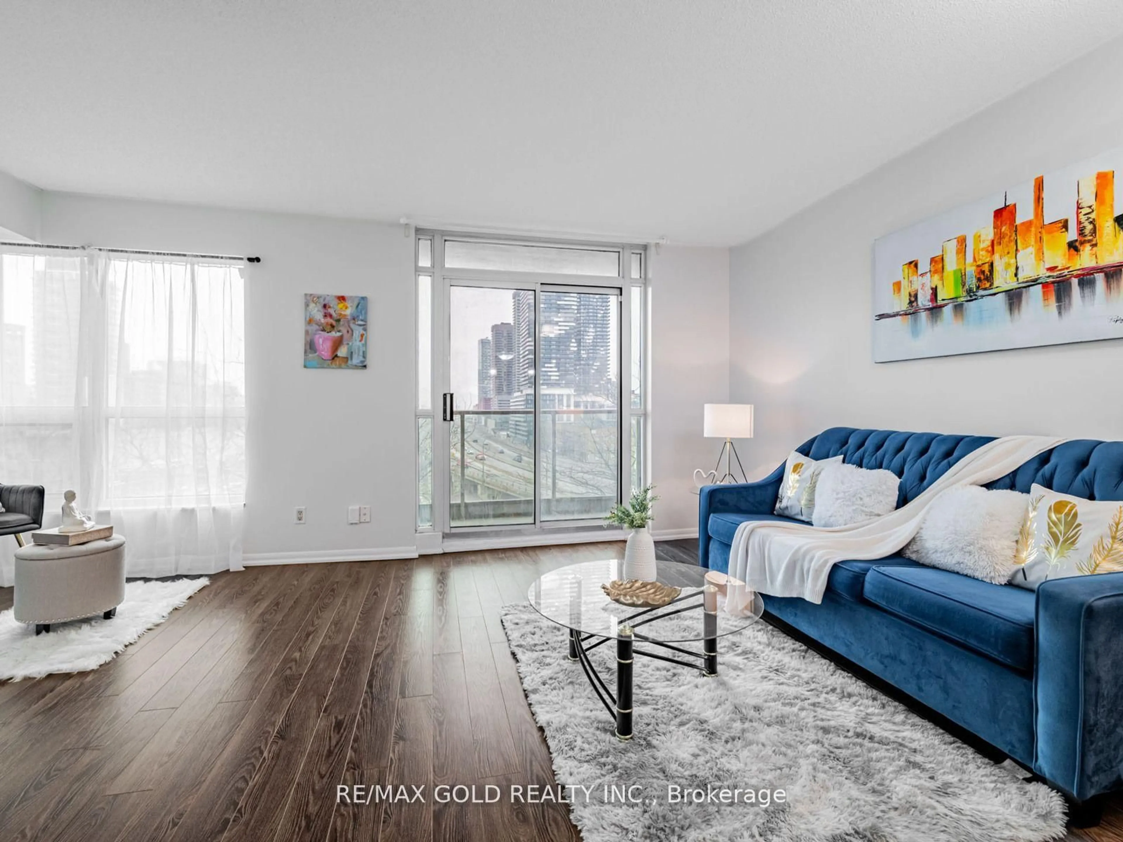 Living room with furniture, wood/laminate floor for 18 Yonge St #906, Toronto Ontario M5E 1R4