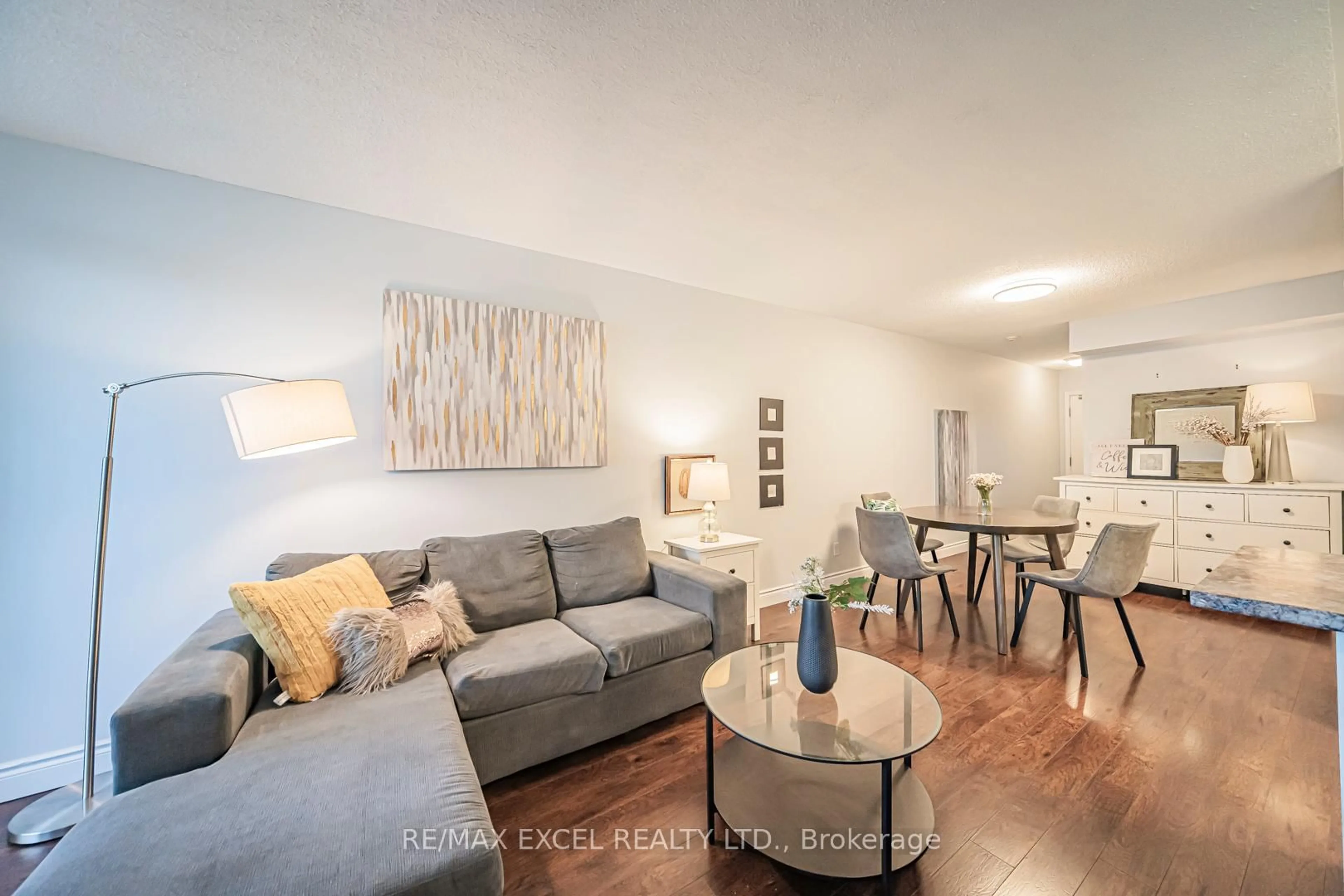 Living room with furniture, wood/laminate floor for 8 Rean Dr #413, Toronto Ontario M2K 3B9