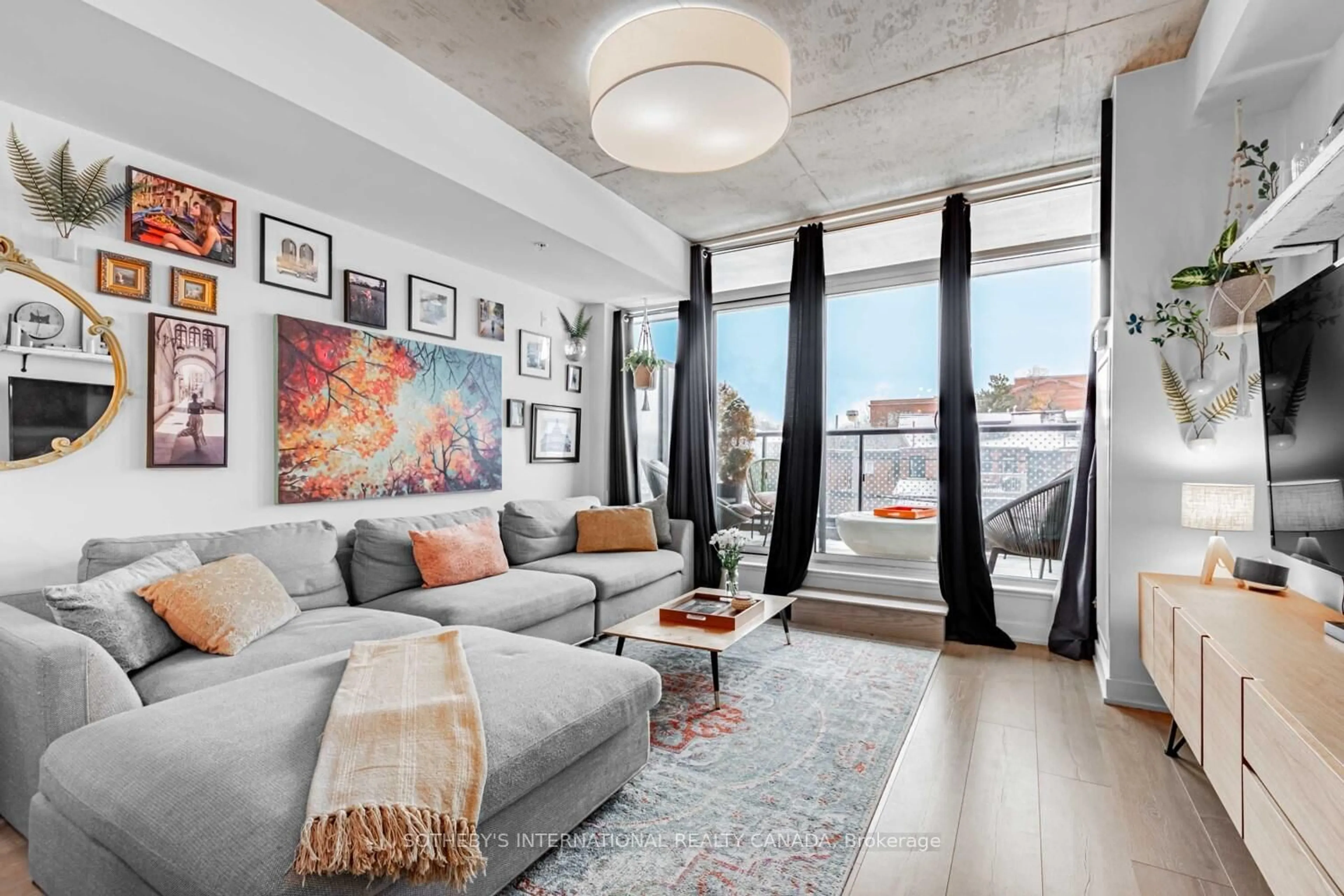 Living room with furniture, cement floor for 109 Ossington Ave #216, Toronto Ontario M6J 0G1