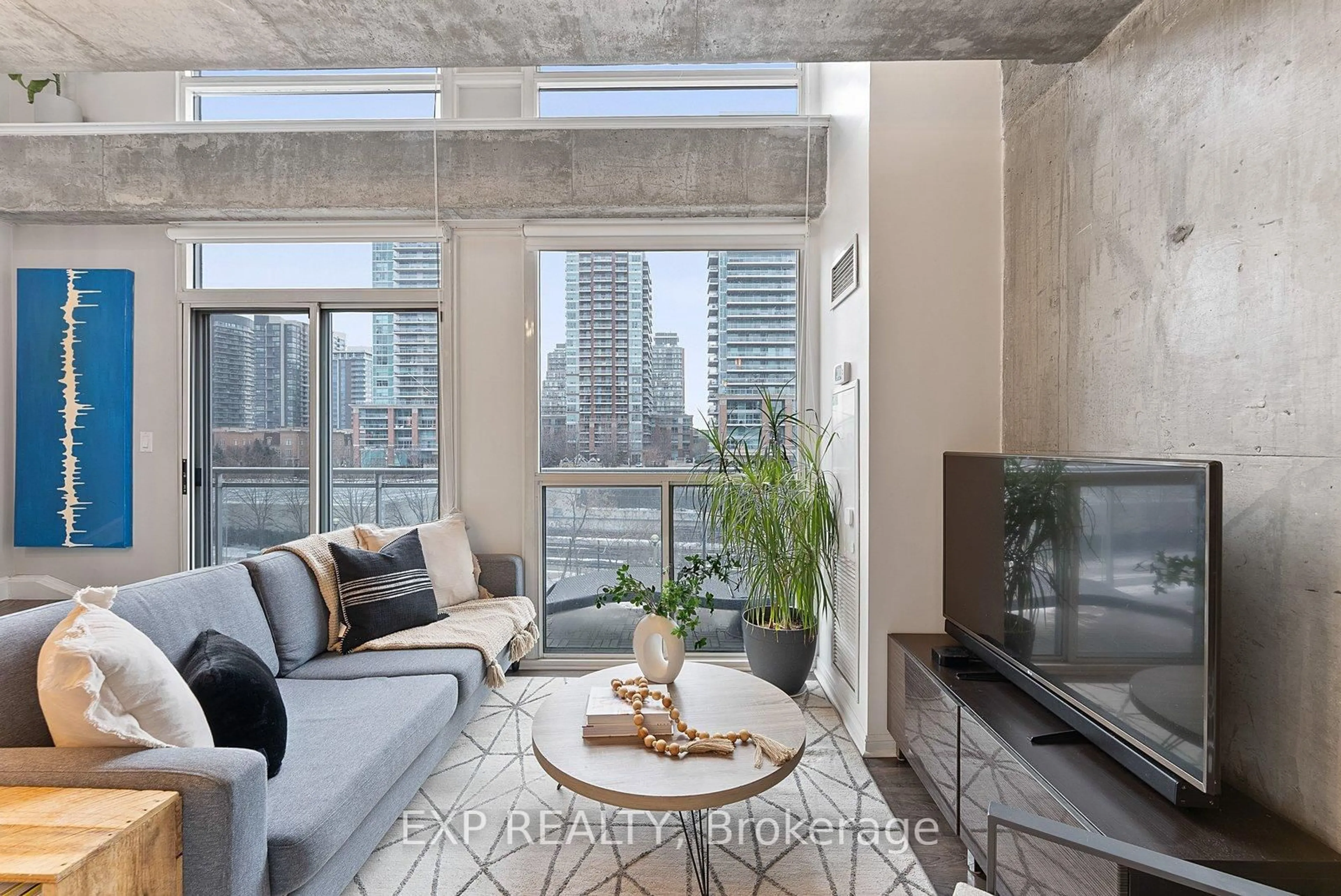 Living room with furniture, cement floor for 1029 King St #401, Toronto Ontario M6K 1J7