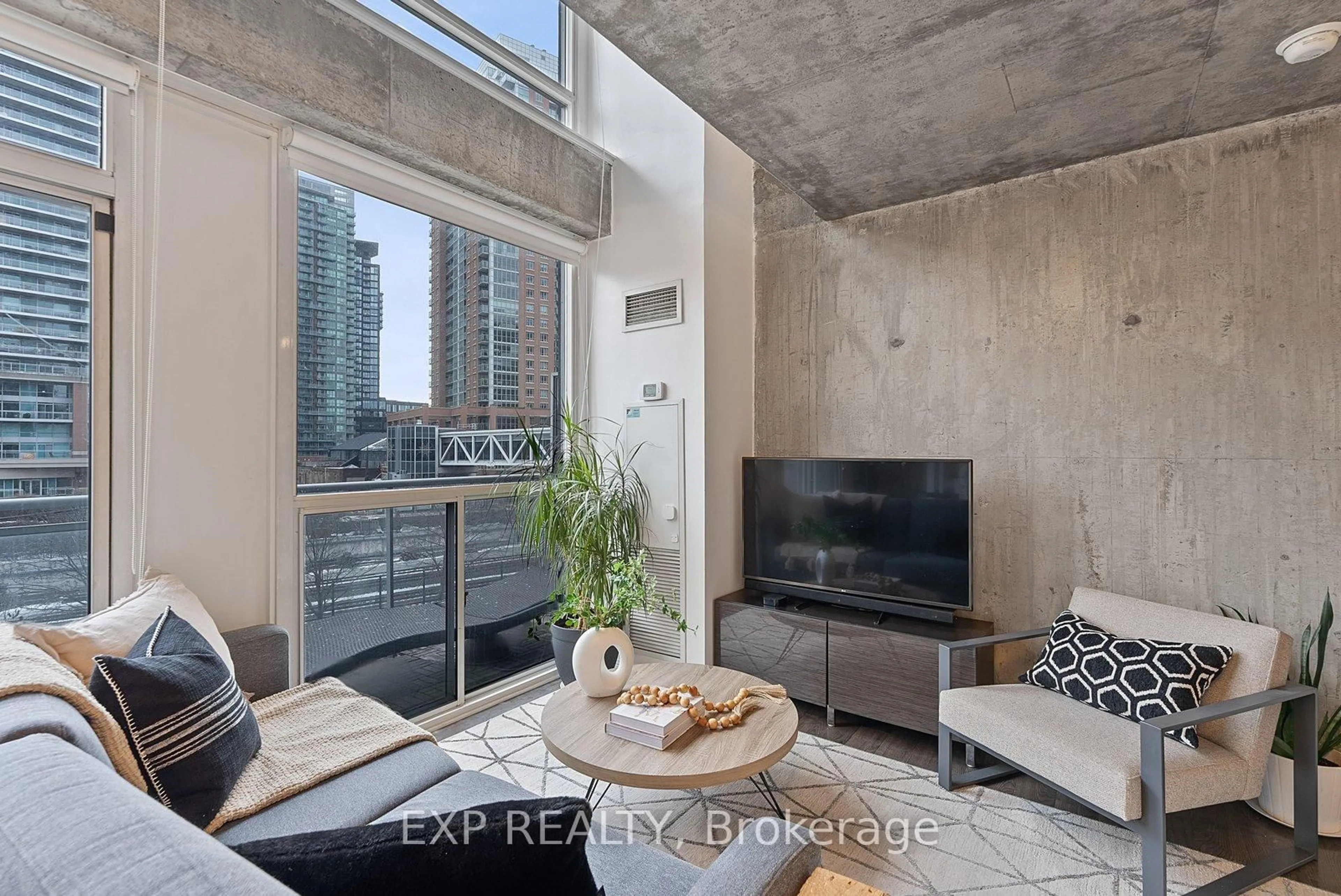 Living room with furniture, cement floor for 1029 King St #401, Toronto Ontario M6K 1J7