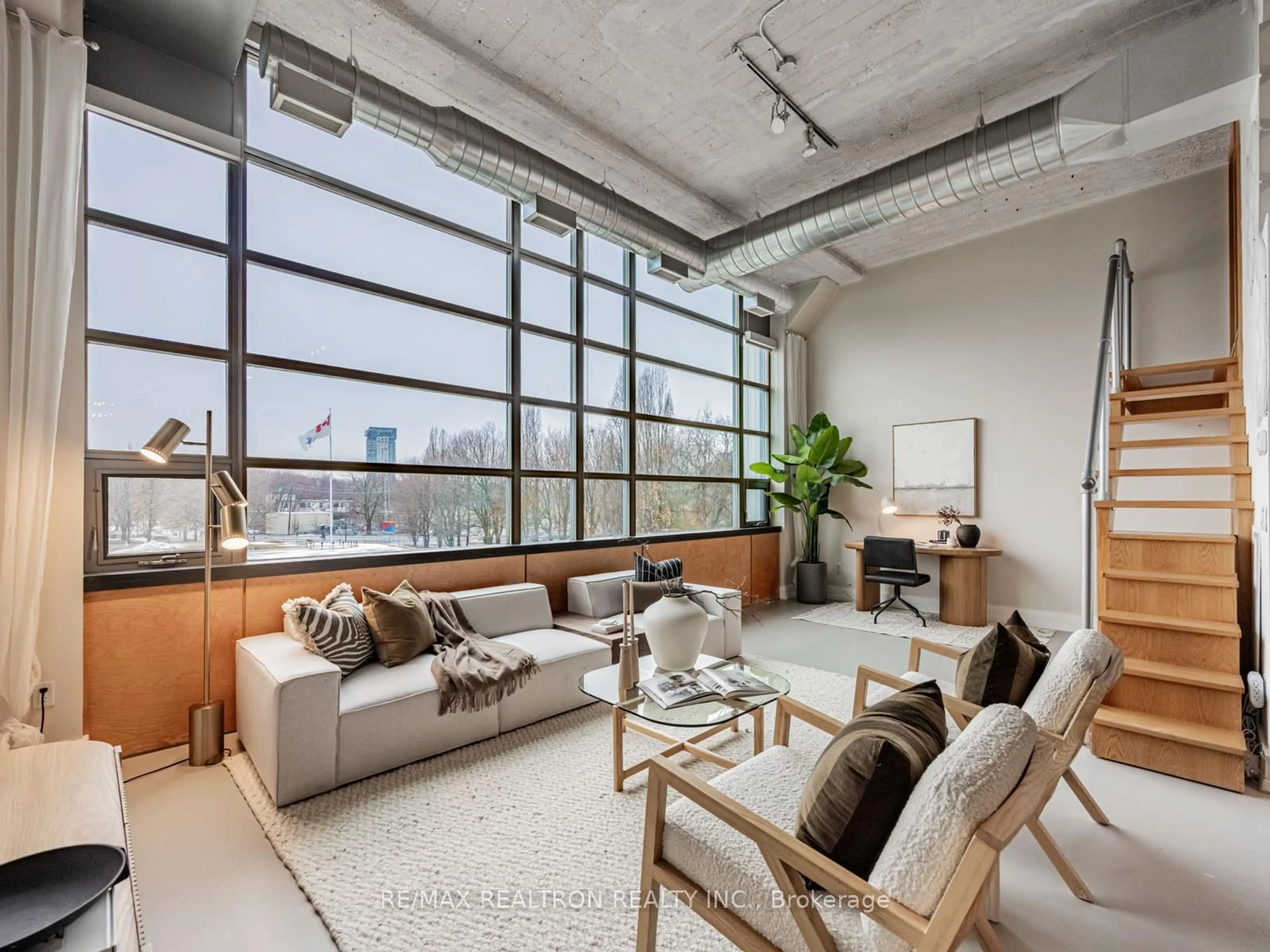 Living room with furniture, cement floor for 637 Lake Shore Blvd #208, Toronto Ontario M5V 3J6