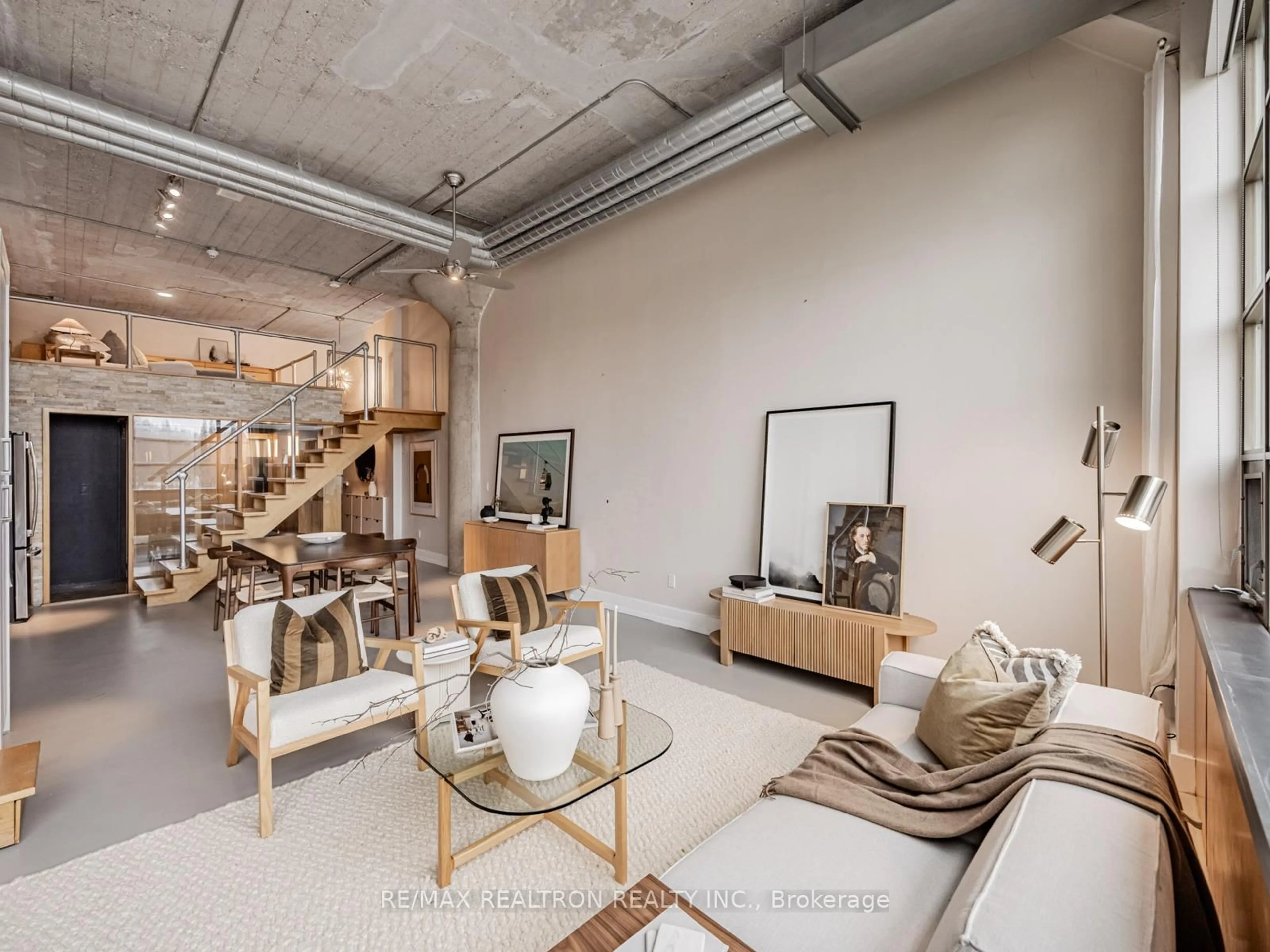 Living room with furniture, cement floor for 637 Lake Shore Blvd #208, Toronto Ontario M5V 3J6