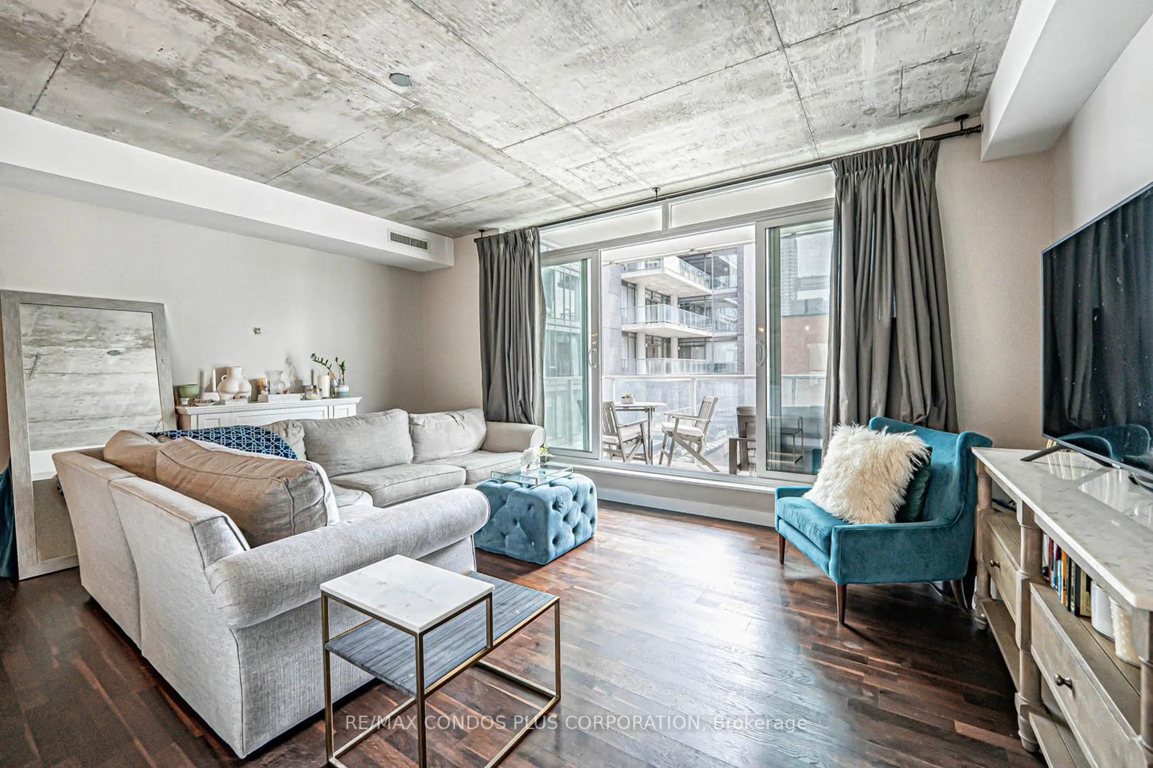 Living room with furniture, cement floor for 75 Portland St #424, Toronto Ontario M5V 2M9