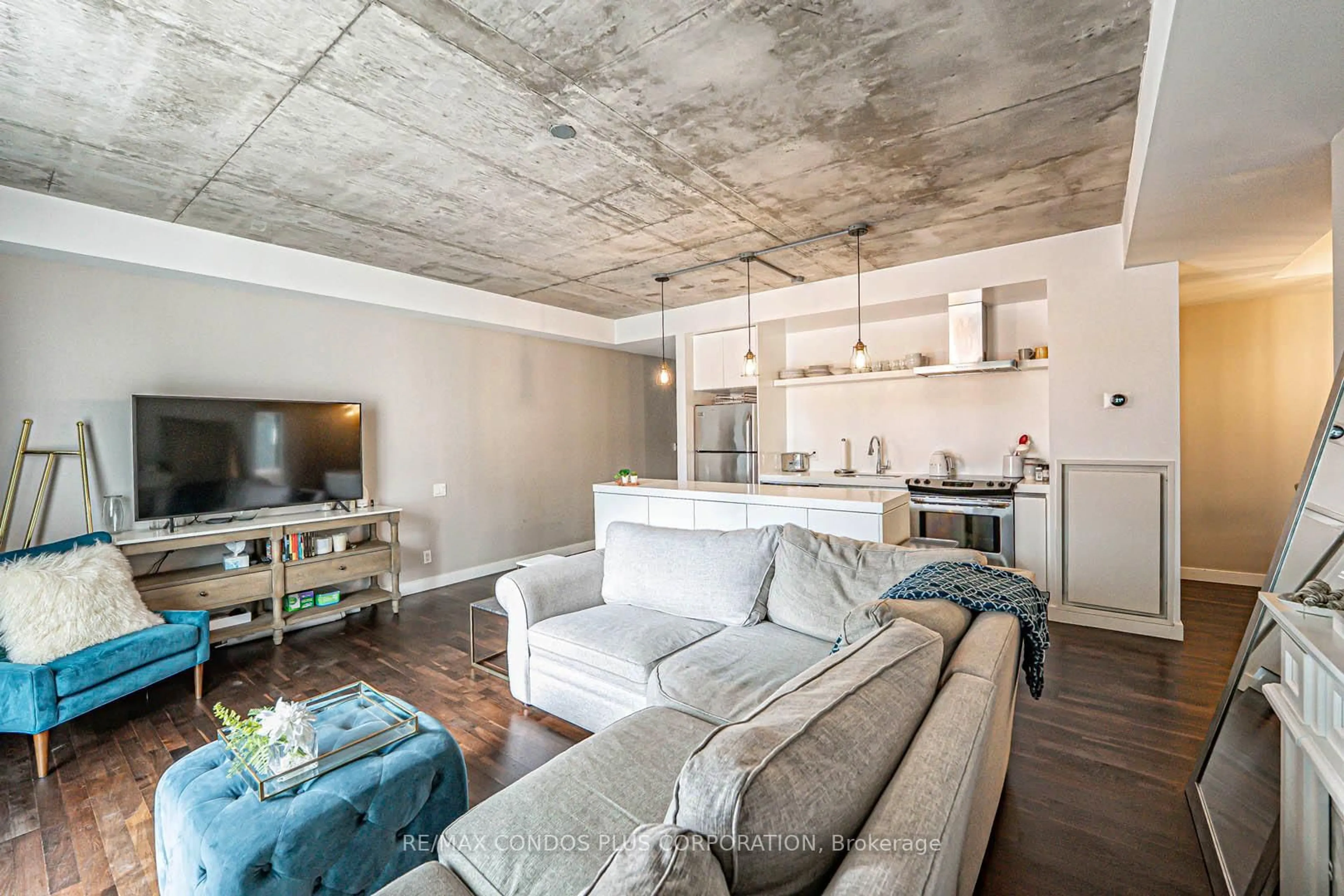 Living room with furniture, cement floor for 75 Portland St #424, Toronto Ontario M5V 2M9