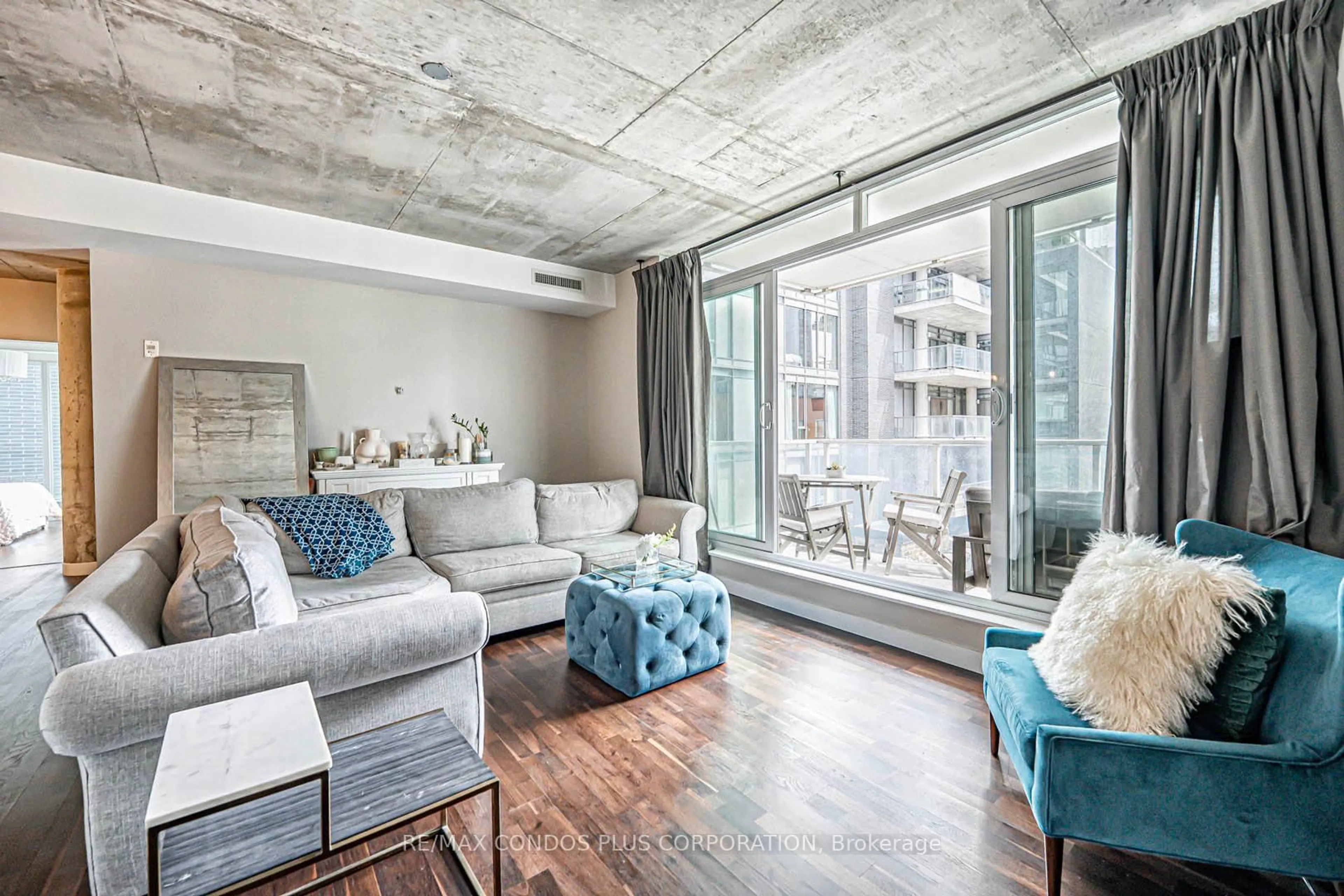 Living room with furniture, cement floor for 75 Portland St #424, Toronto Ontario M5V 2M9