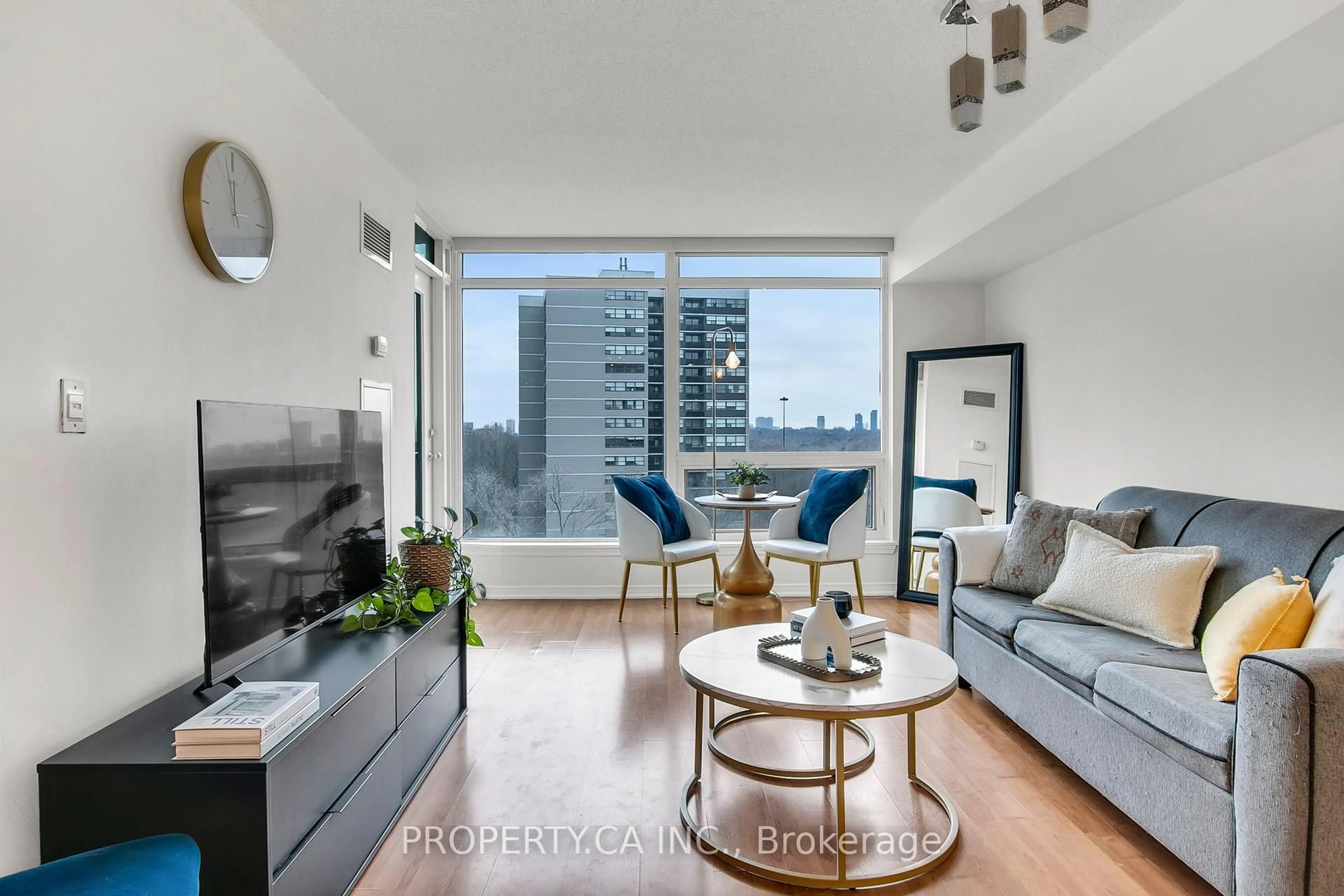 Living room with furniture, wood/laminate floor for 18 Valley Woods Rd #711, Toronto Ontario M3A 0A1