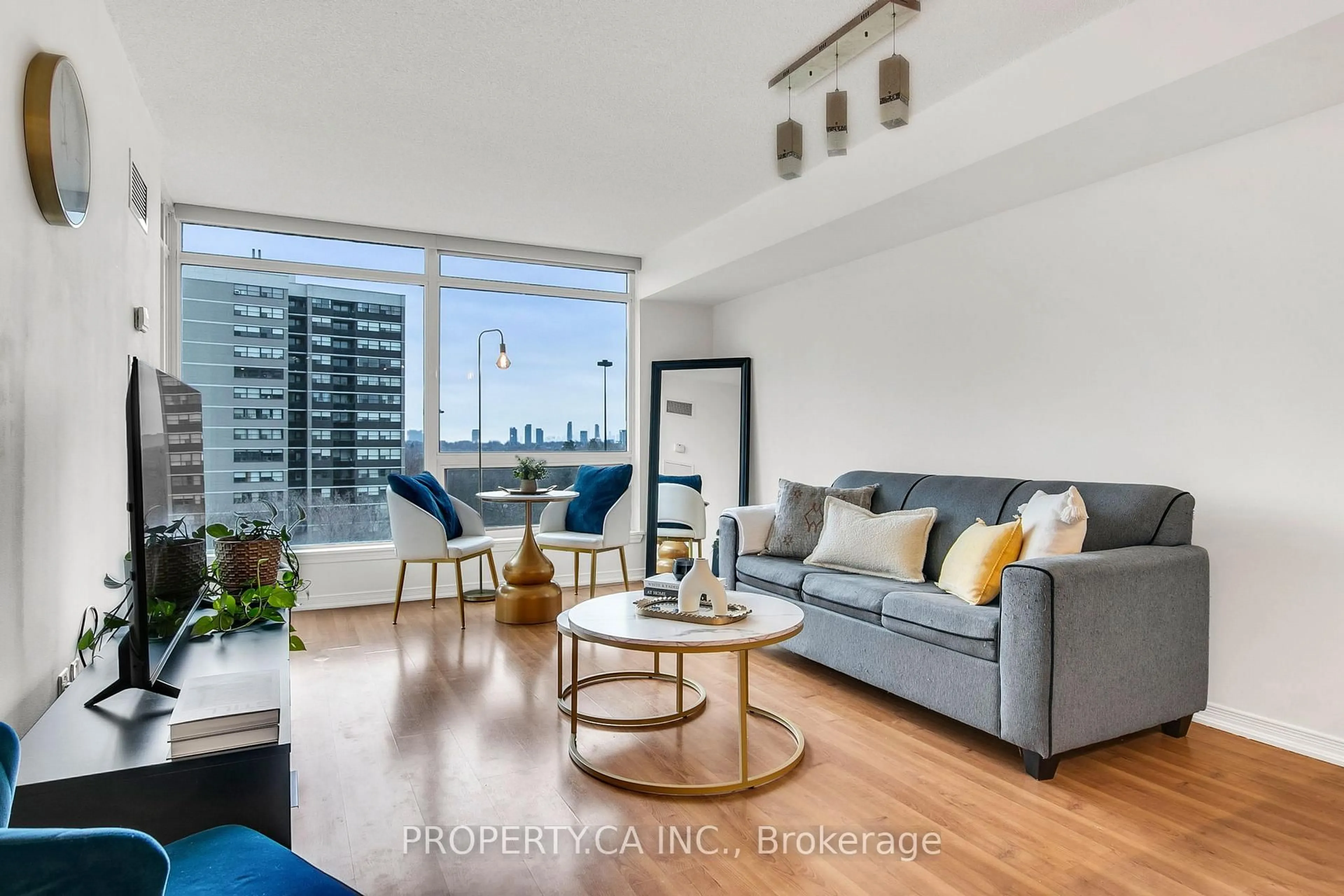 Living room with furniture, wood/laminate floor for 18 Valley Woods Rd #711, Toronto Ontario M3A 0A1