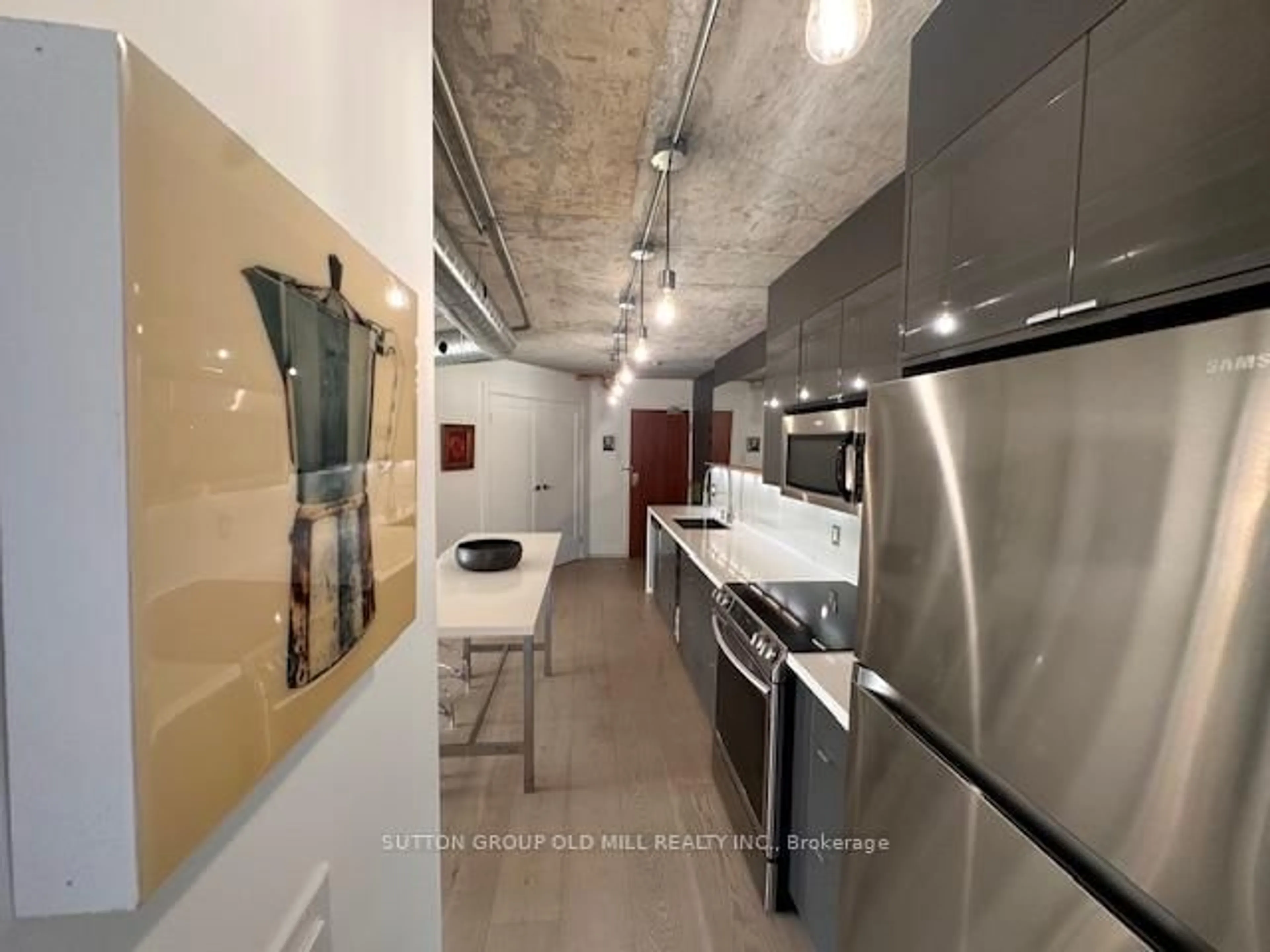 Kitchen with laundary machines, cement floor for 456 College St #211, Toronto Ontario M6G 4A3