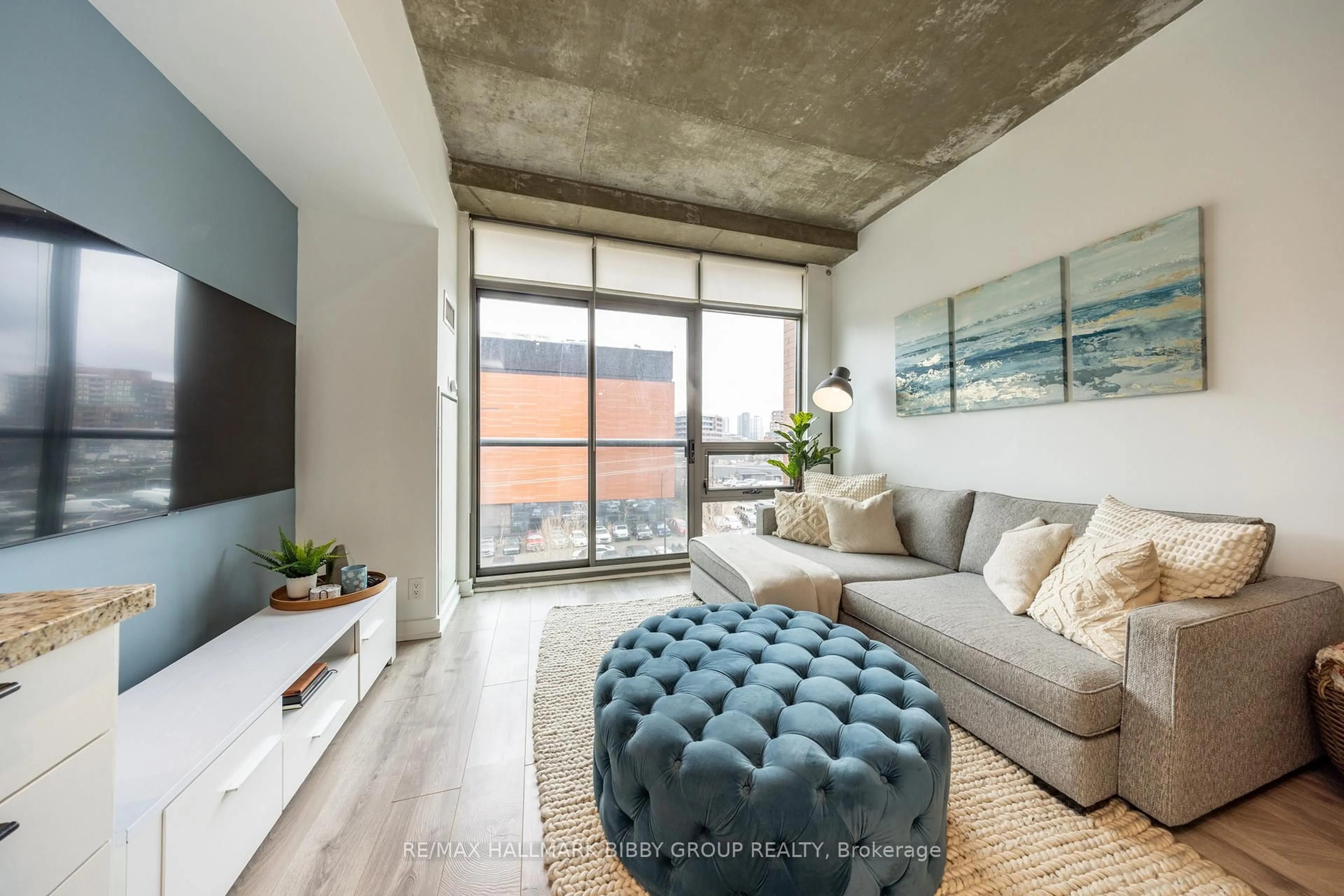 Living room with furniture, cement floor for 33 Mill St #447, Toronto Ontario M5A 3R3