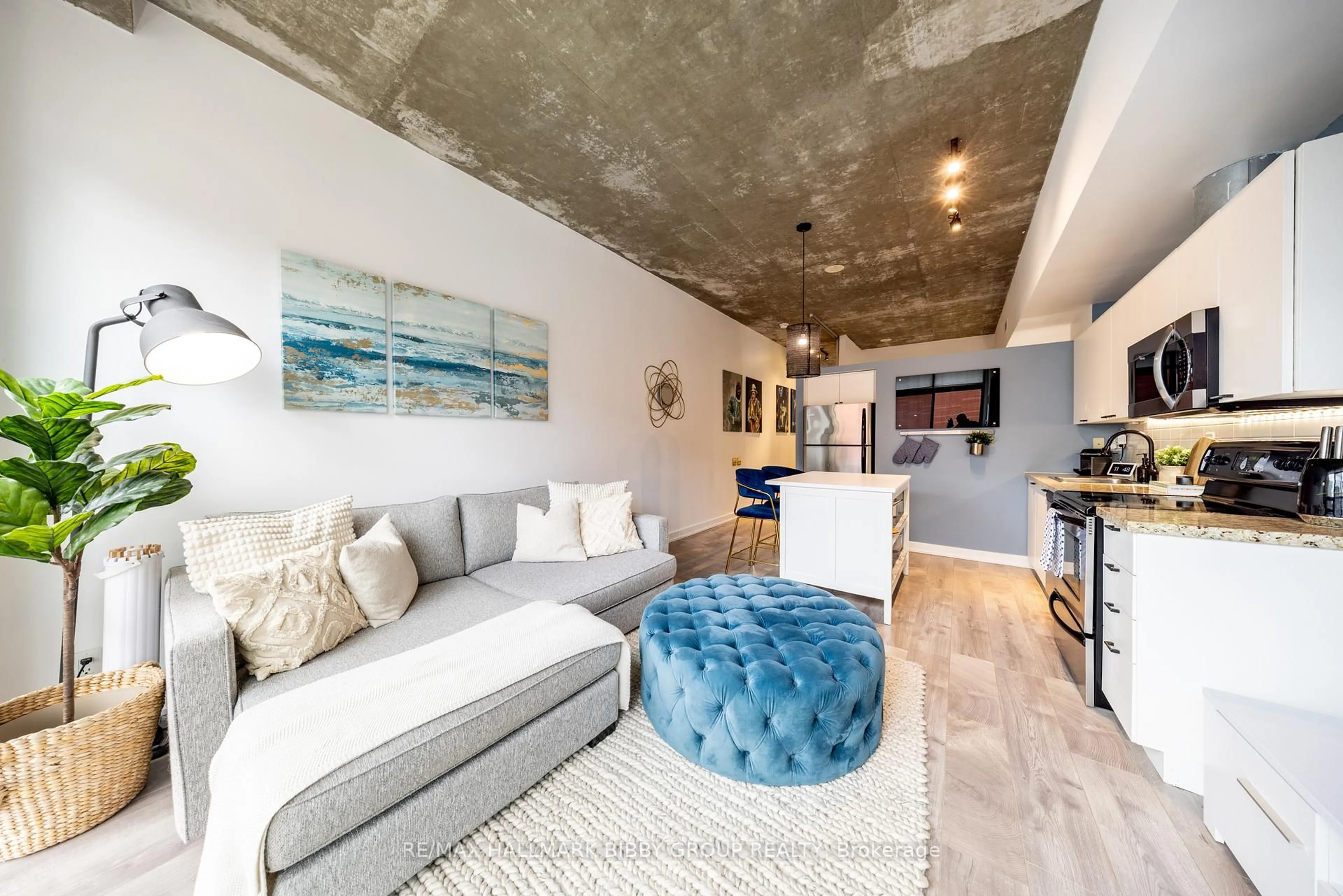 Living room with furniture, cement floor for 33 Mill St #447, Toronto Ontario M5A 3R3