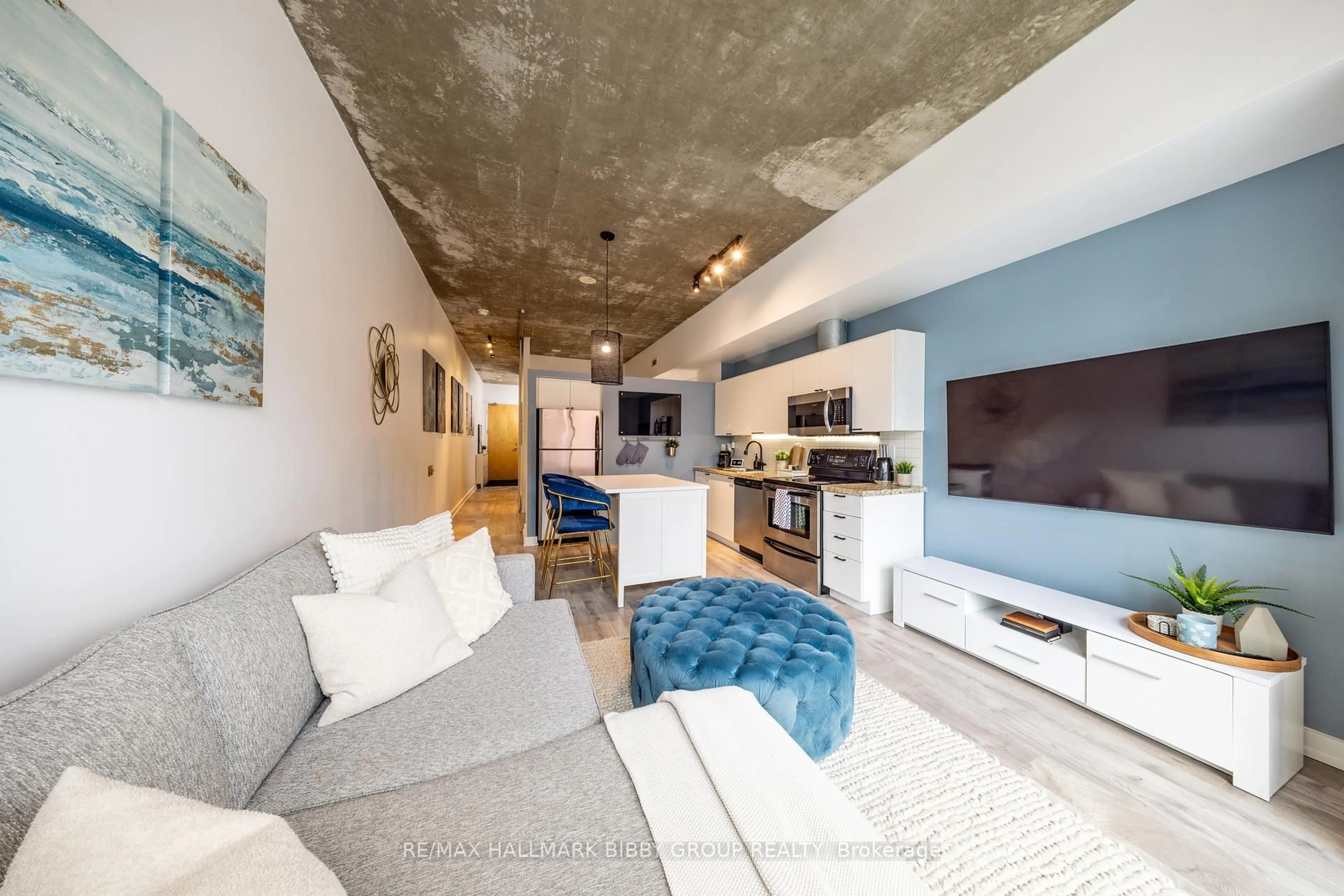 Living room with furniture, cement floor for 33 Mill St #447, Toronto Ontario M5A 3R3