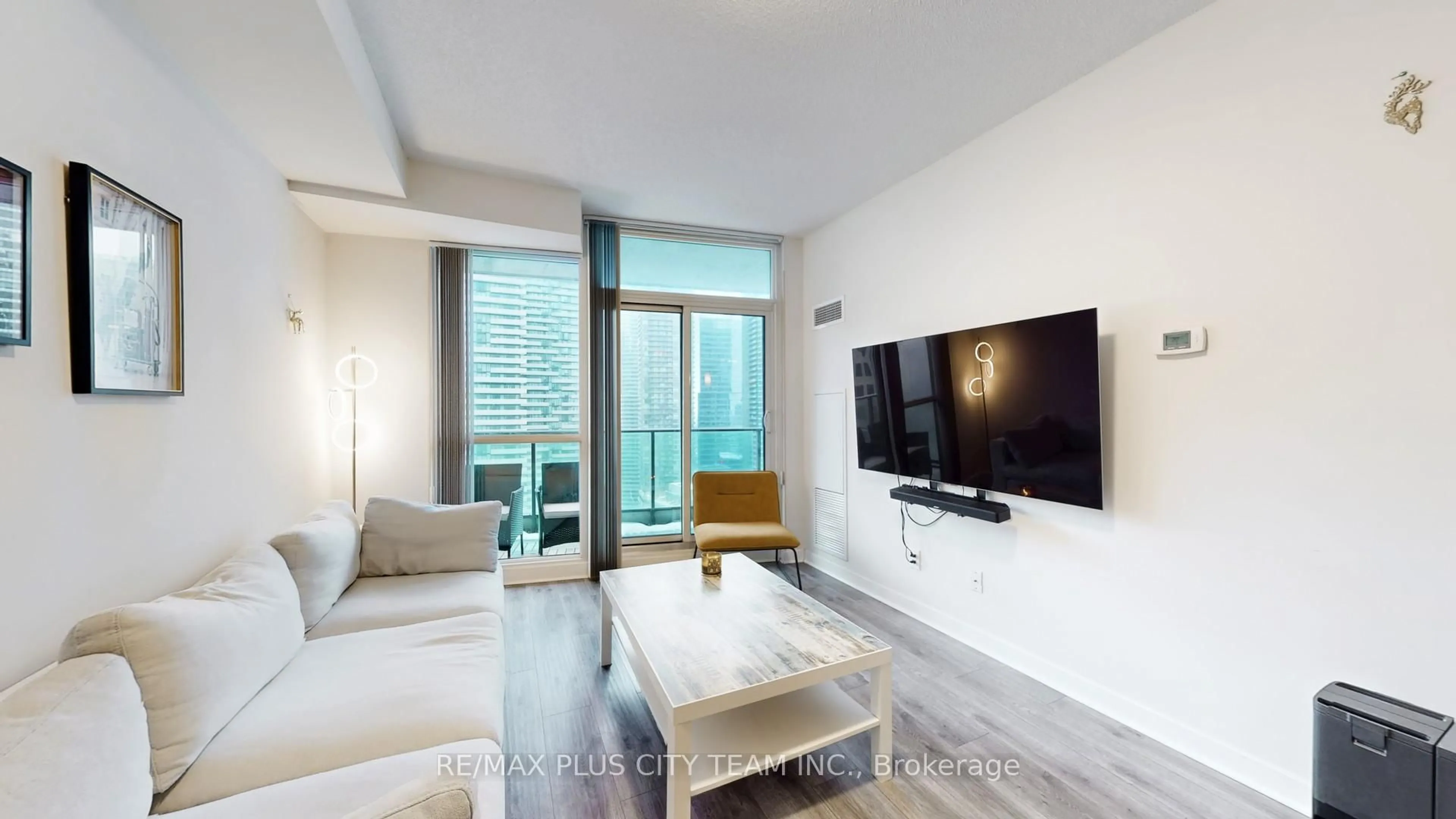 Living room with furniture, wood/laminate floor for 33 Bay St #2902, Toronto Ontario M5J 2Z3