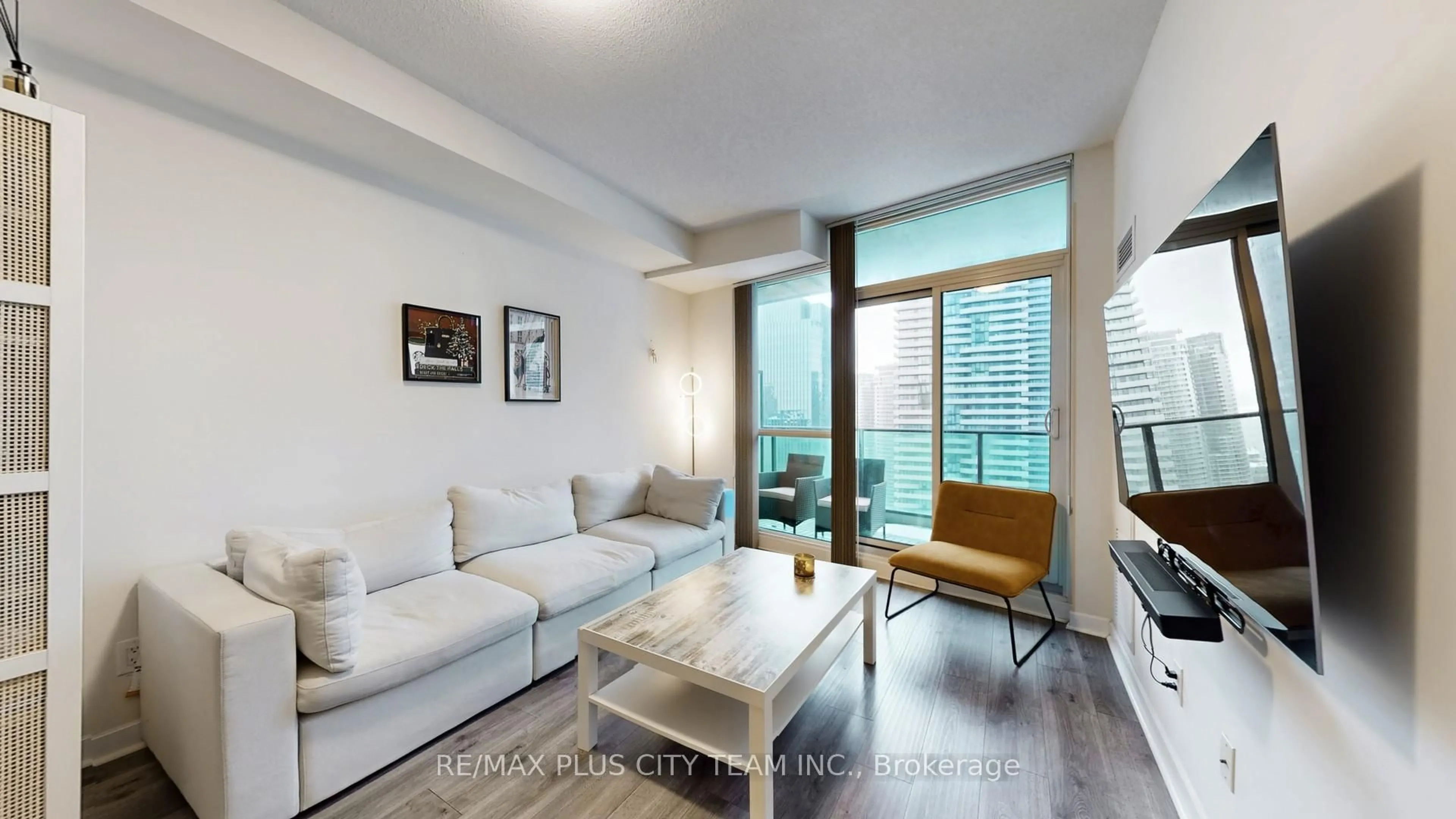 Living room with furniture, wood/laminate floor for 33 Bay St #2902, Toronto Ontario M5J 2Z3