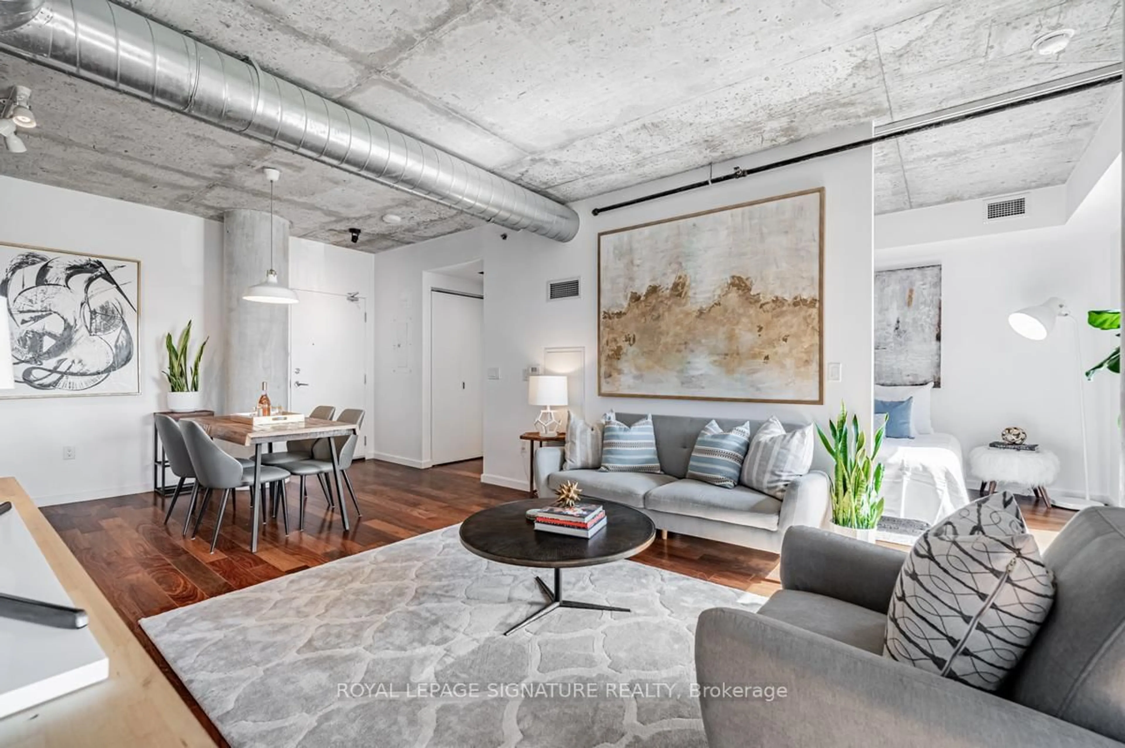 Living room with furniture, cement floor for 51 Trolley Cres #405, Toronto Ontario M5A 0E9