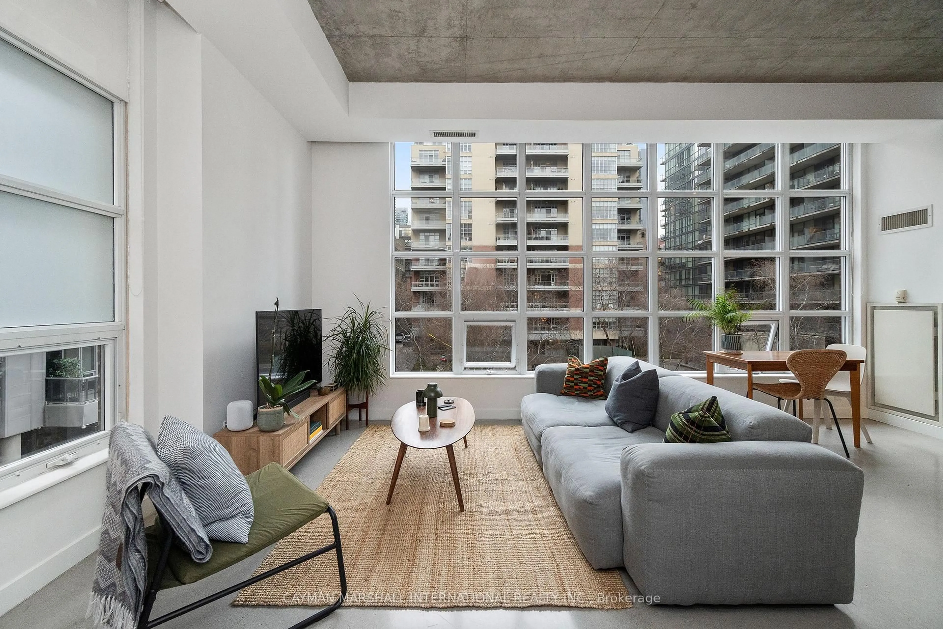 Living room with furniture, cement floor for 19 Brant St #309, Toronto Ontario M5V 2L2