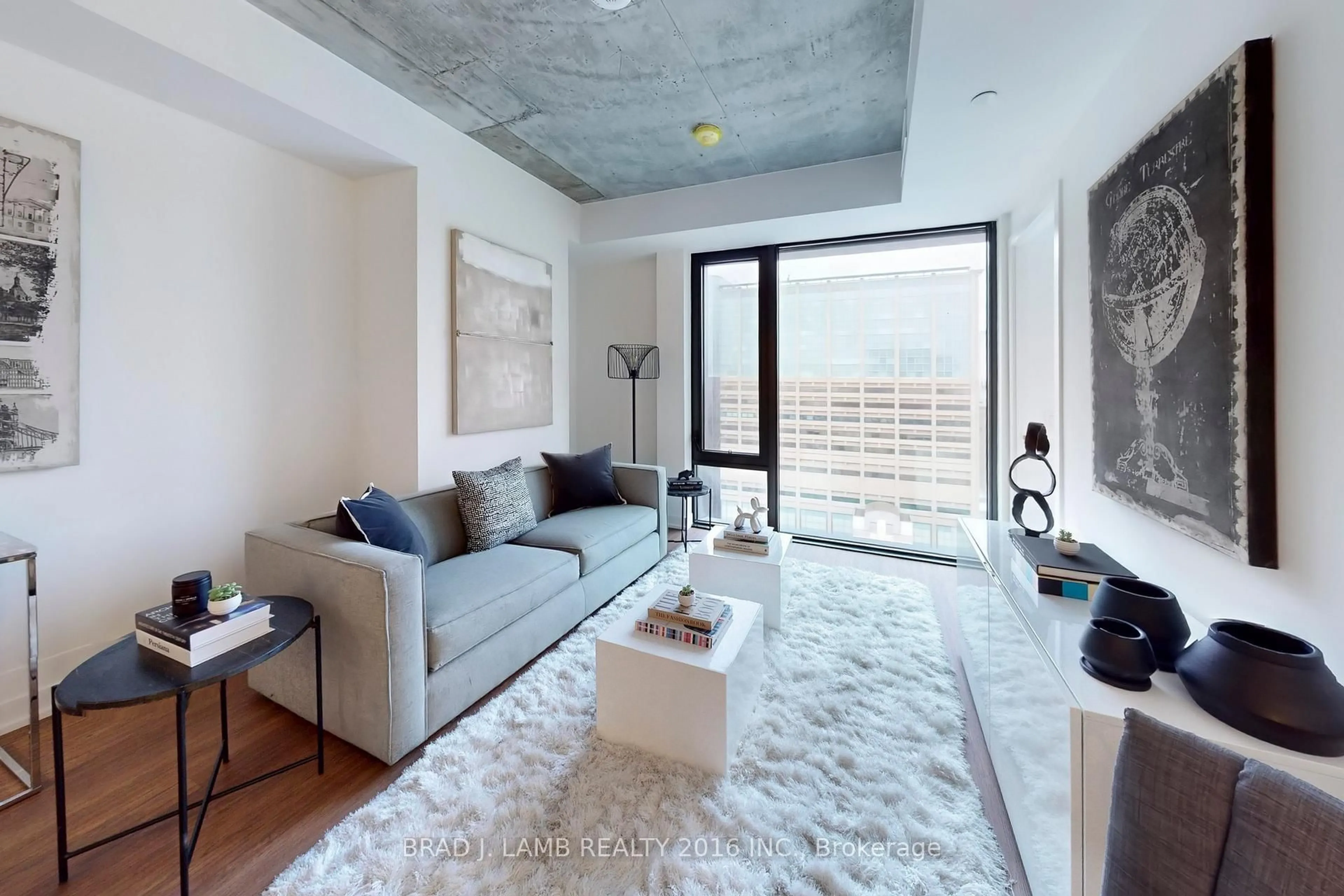 Living room with furniture, cement floor for 195 McCaul St #1403, Toronto Ontario M5T 0E5