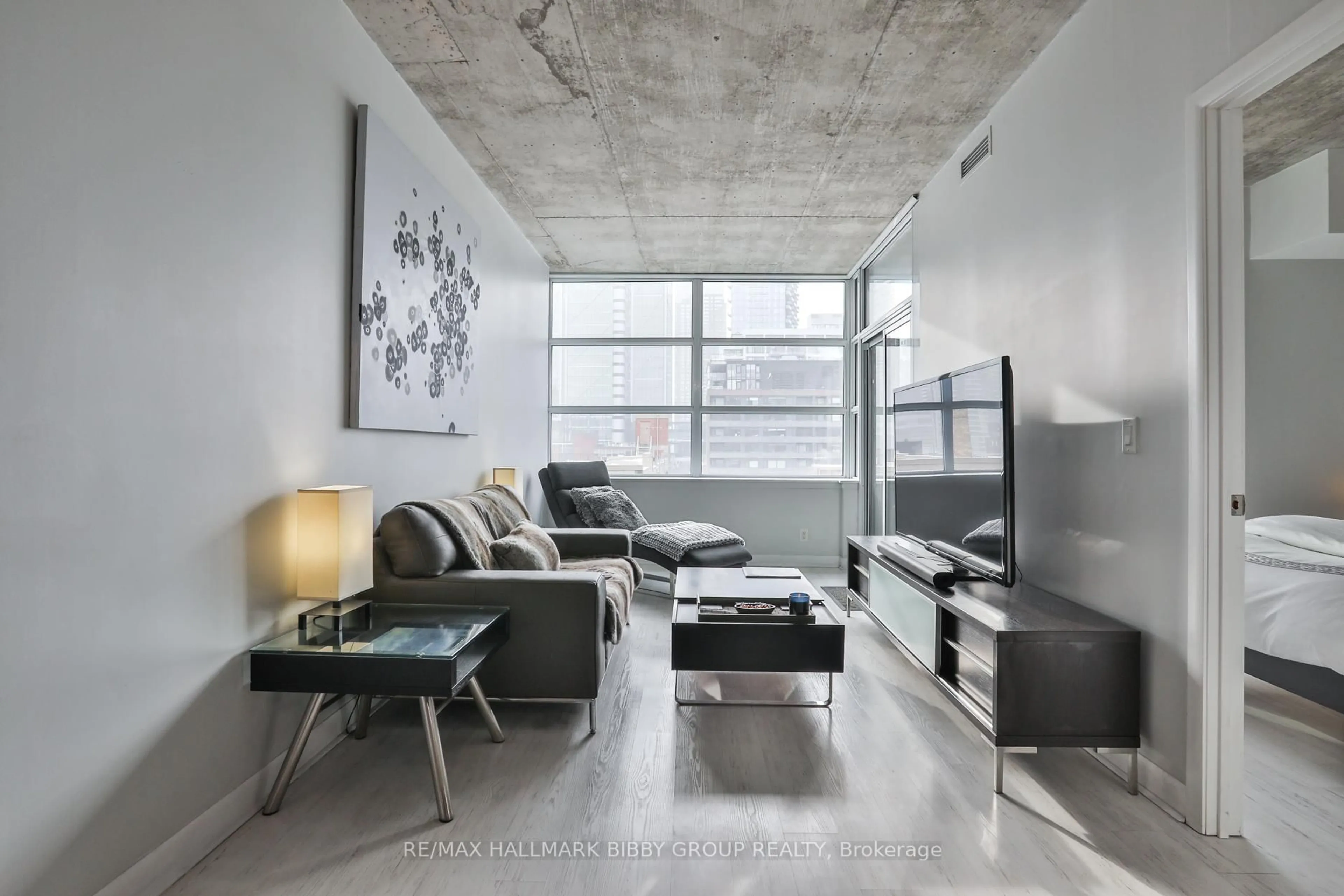 Living room with furniture, cement floor for 478 King St #606, Toronto Ontario M5V 0A8