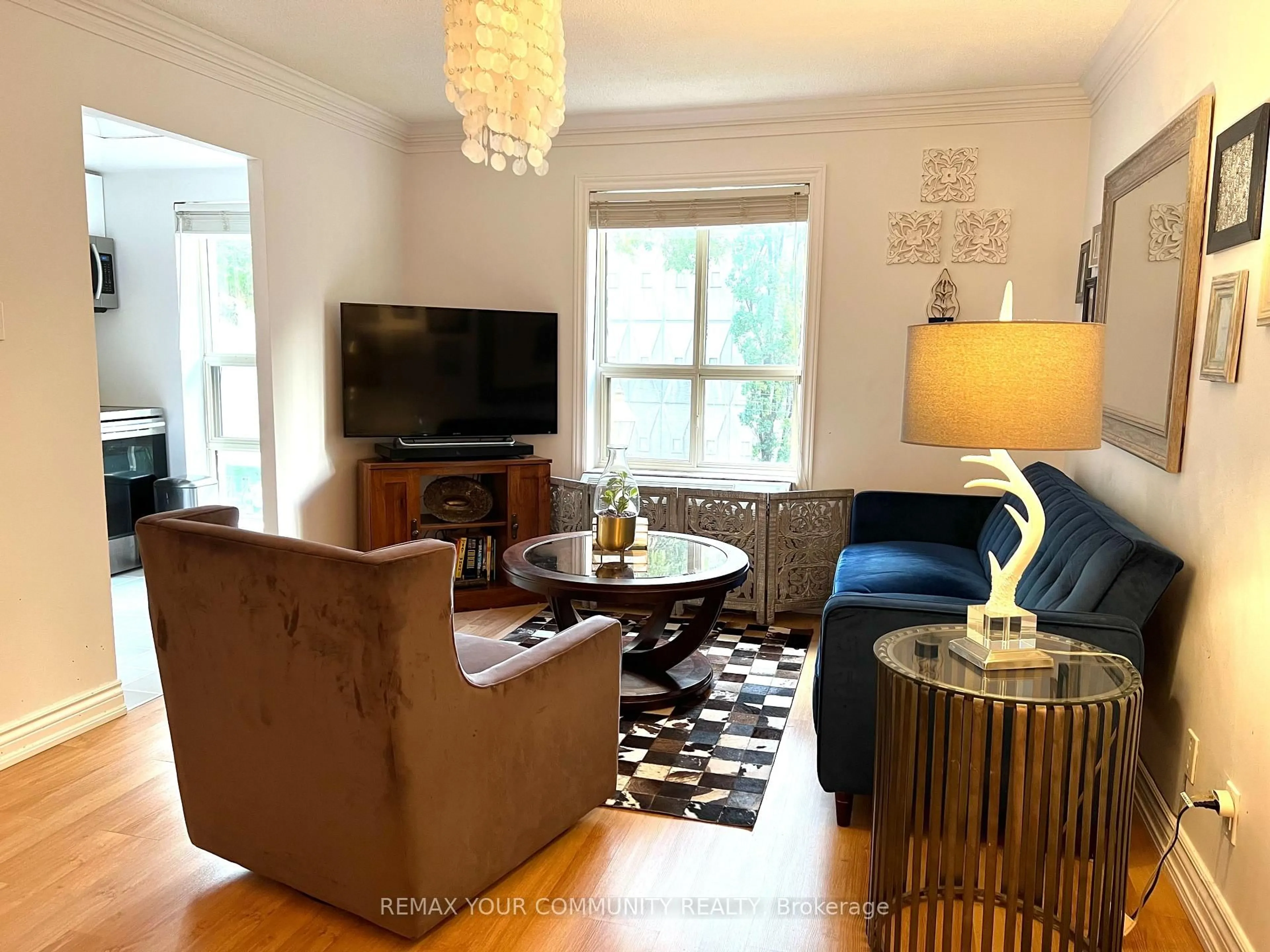 Living room with furniture, wood/laminate floor for 88 Charles St #211, Toronto Ontario M4Y 2W7